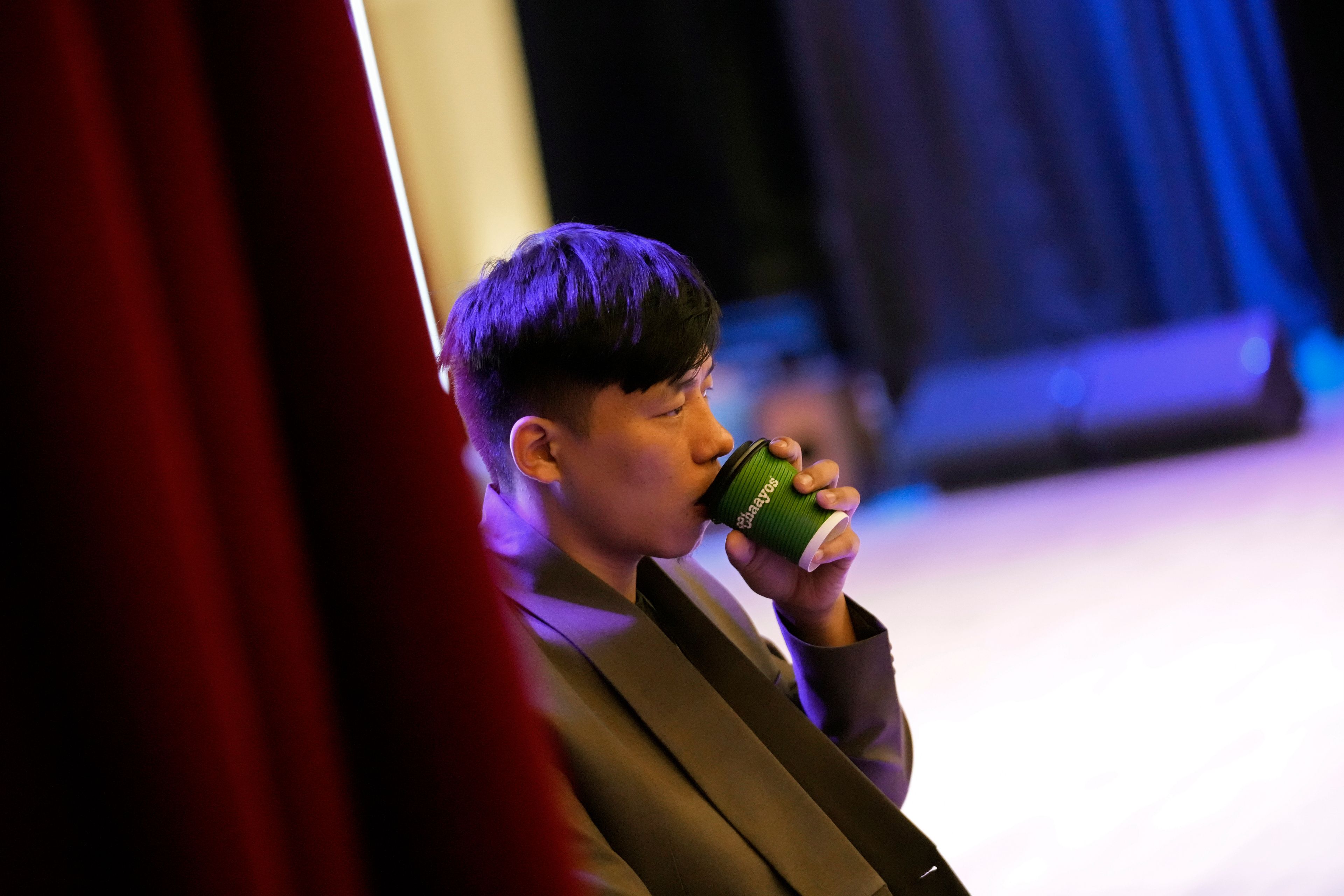 Takosangba Jamir, 27, a blind pianist, drinks tea as he waits for his turn to rehearse during the two-day Brillante Piano Festival in Bengaluru, India, Sunday, Sept. 29, 2024. (AP Photo/Aijaz Rahi)