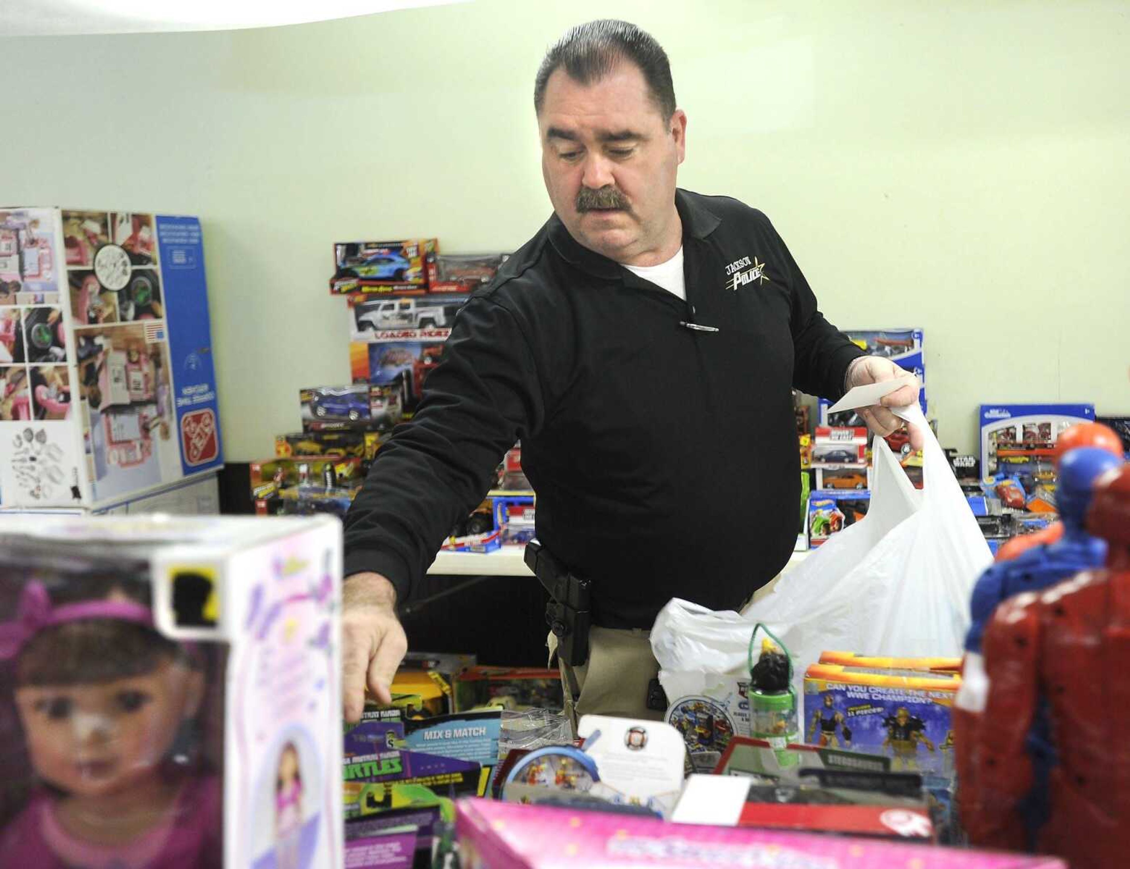 Jackson Police Capt. Scott Eakers fills a toy order from the department's annual toy drive Friday at the Jackson Elks Lodge. (Fred Lynch)