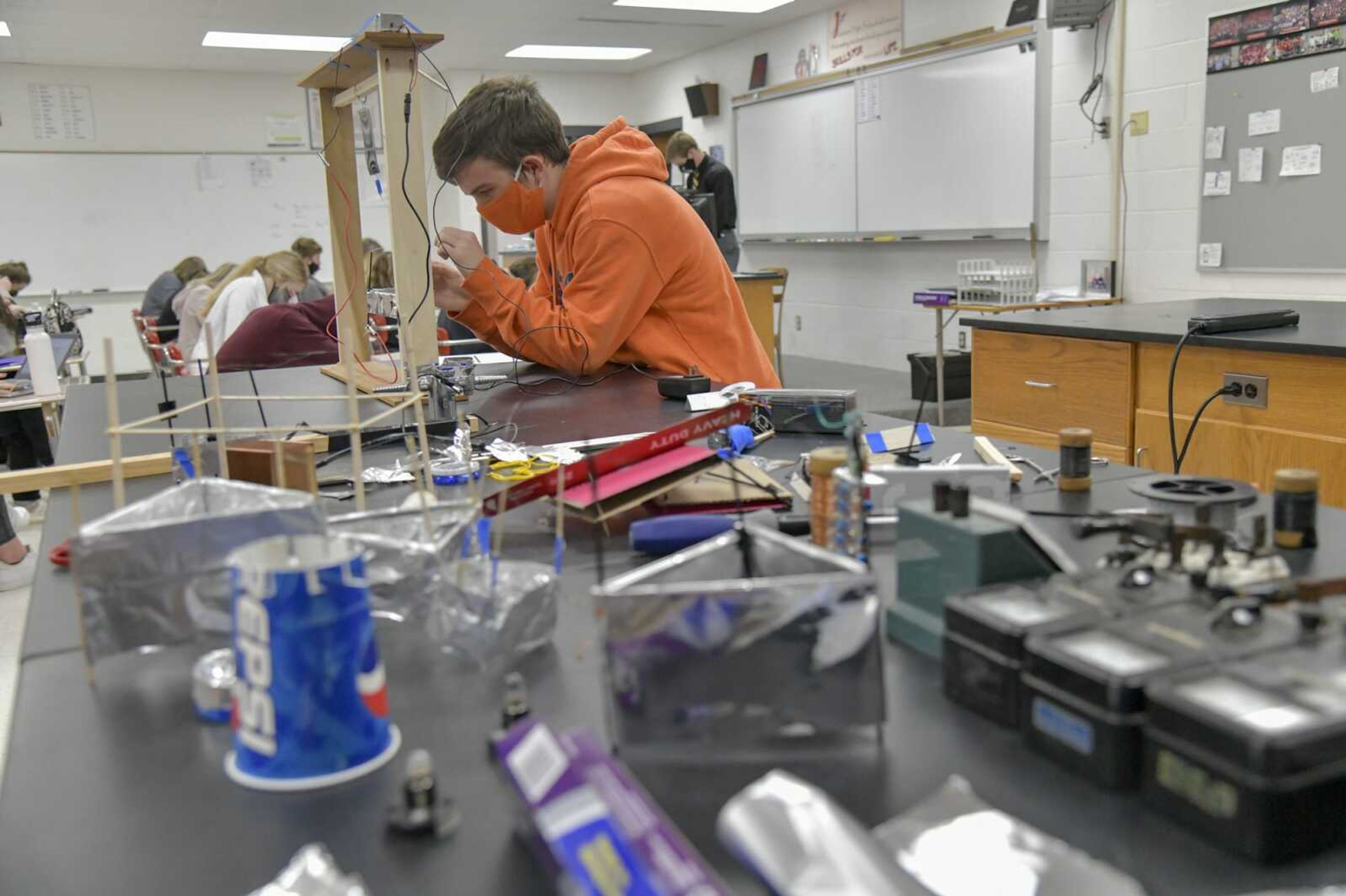 Senior and stipend receiver Tate Friedrich works on his ion-propelled aircraft that employs the Biefeld-Brown Effect in order to produce thrust, movement off the ground, during his free period at Jackson High in Jackson on Jan. 21, 2021. He is using similar research from MIT that he found in a science magazine over a year ago and has been perfecting his own version since to find a model that is the most efficient. Friedrich said that there is not a lot of research on the phenomenon, so he is figuring out a lot through his own trial and error, as seen through the materials and past models he has used, front.