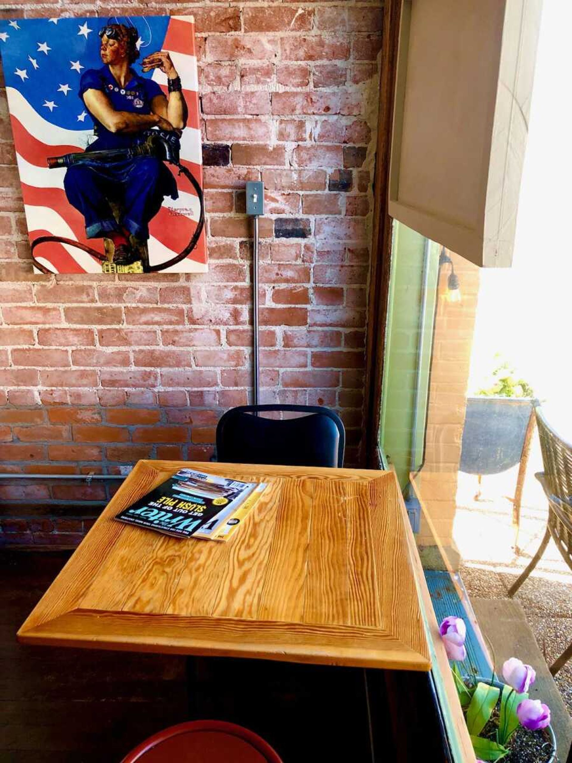 This cozy corner table is the perfect spot to take in the atmosphere inside and outside of the charming cafe.