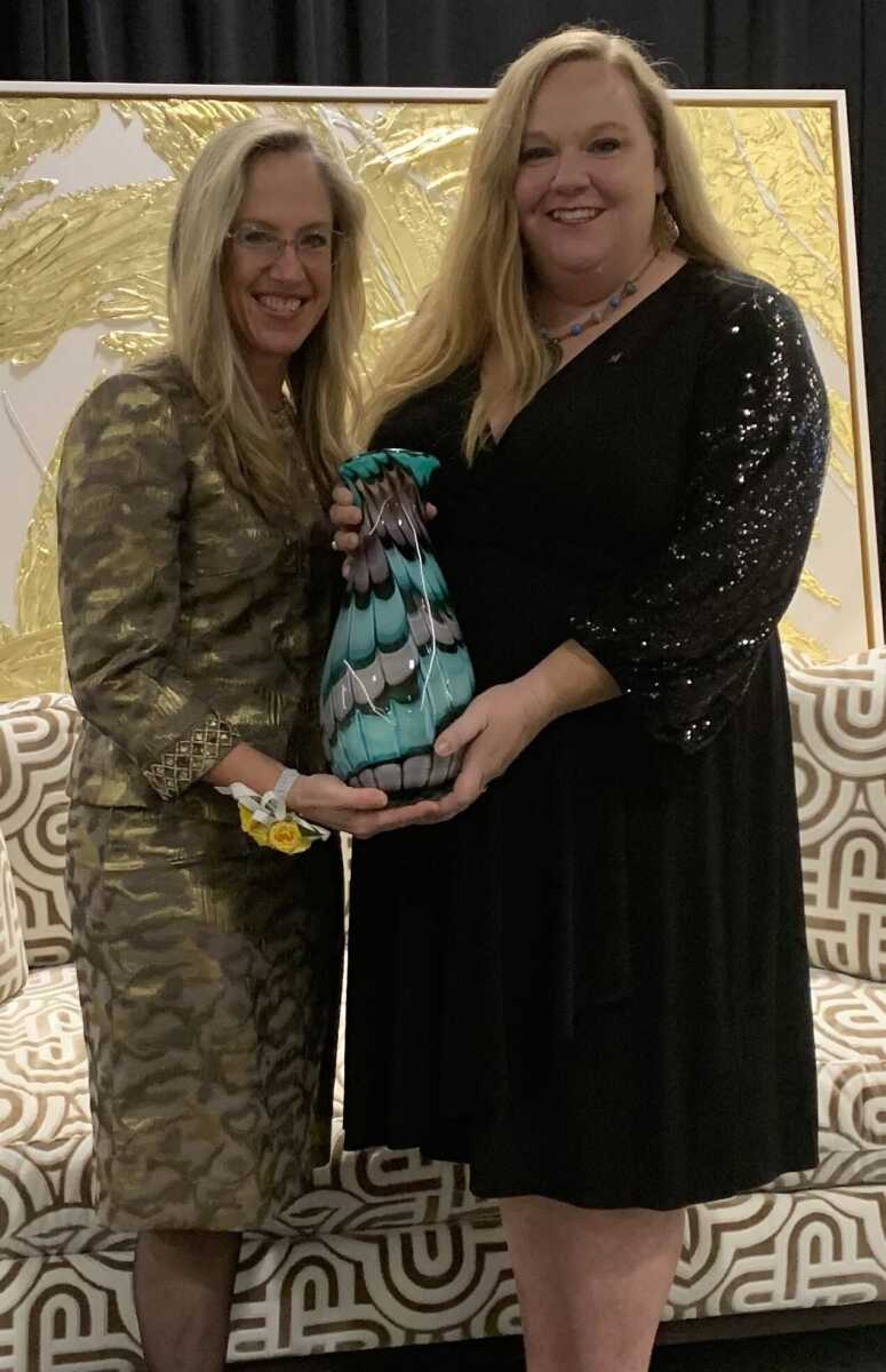 Abbie Crites-Leoni, left, is presented a Celebration Award by Amanda Lincoln during the Zonta Women of Achievement luncheon on 
Friday, Nov. 17, at the Drury Plaza Hotel Conference Center in Cape 
Girardeau.