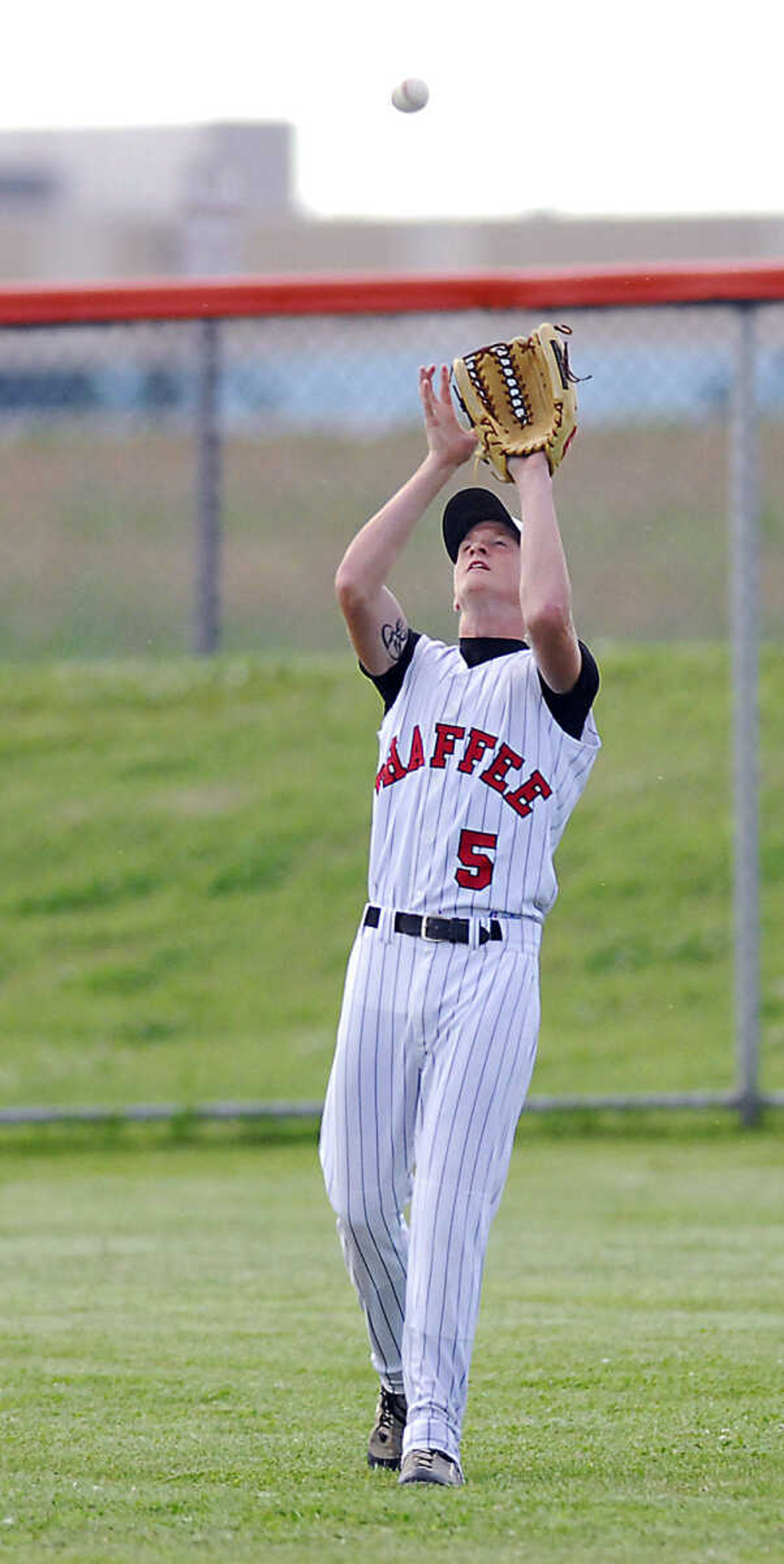 Center fielder Trenton Horman catches a fly ball Monday, May 11, 2009, at Central High in Cape Girardeau.