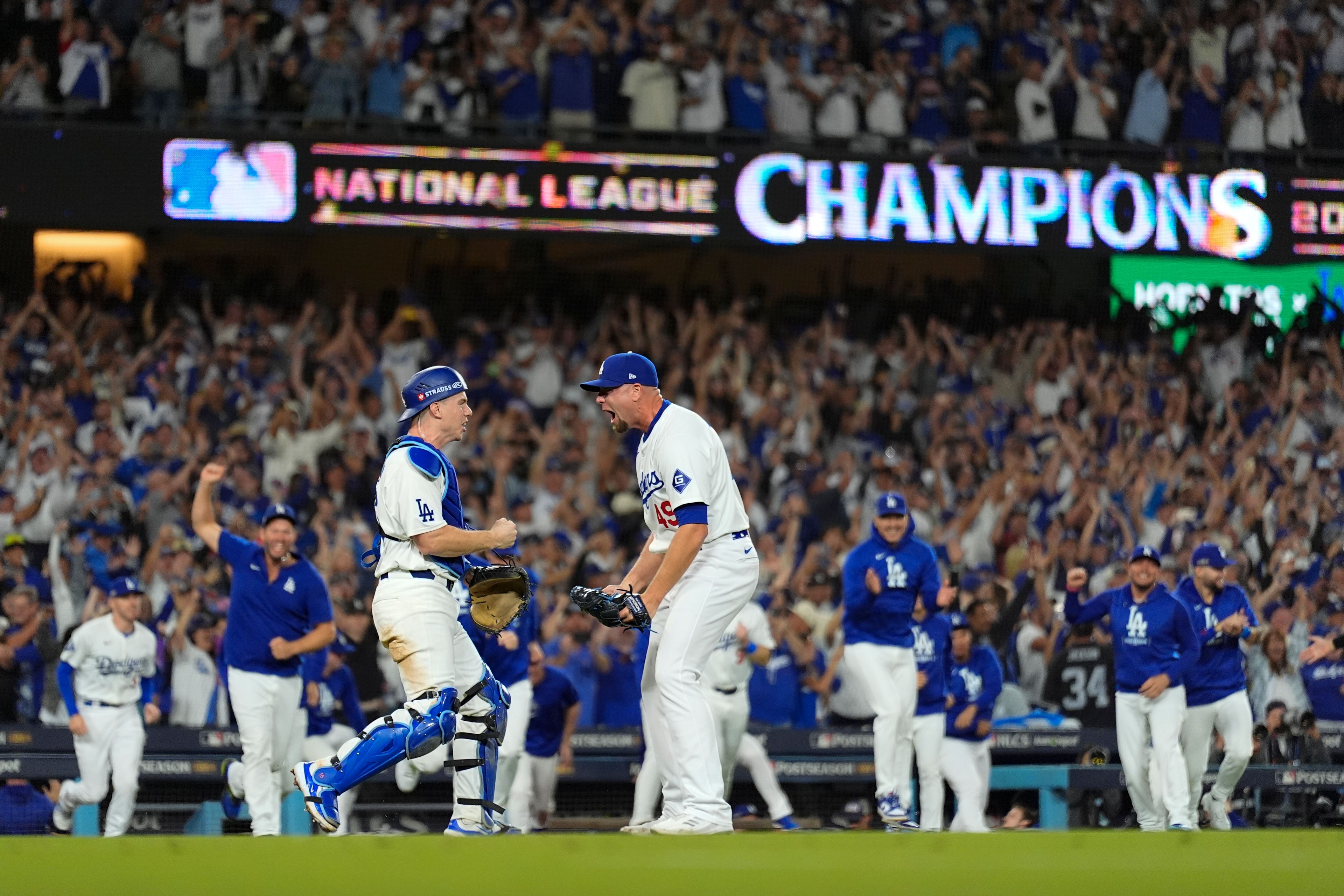 Los Angeles Dodgers pitcher Blake Treinen and catcher Will Smith celebrate their win against the New York Mets in Game 6 of a baseball NL Championship Series, Sunday, Oct. 20, 2024, in Los Angeles. (AP Photo/Julio Cortez)