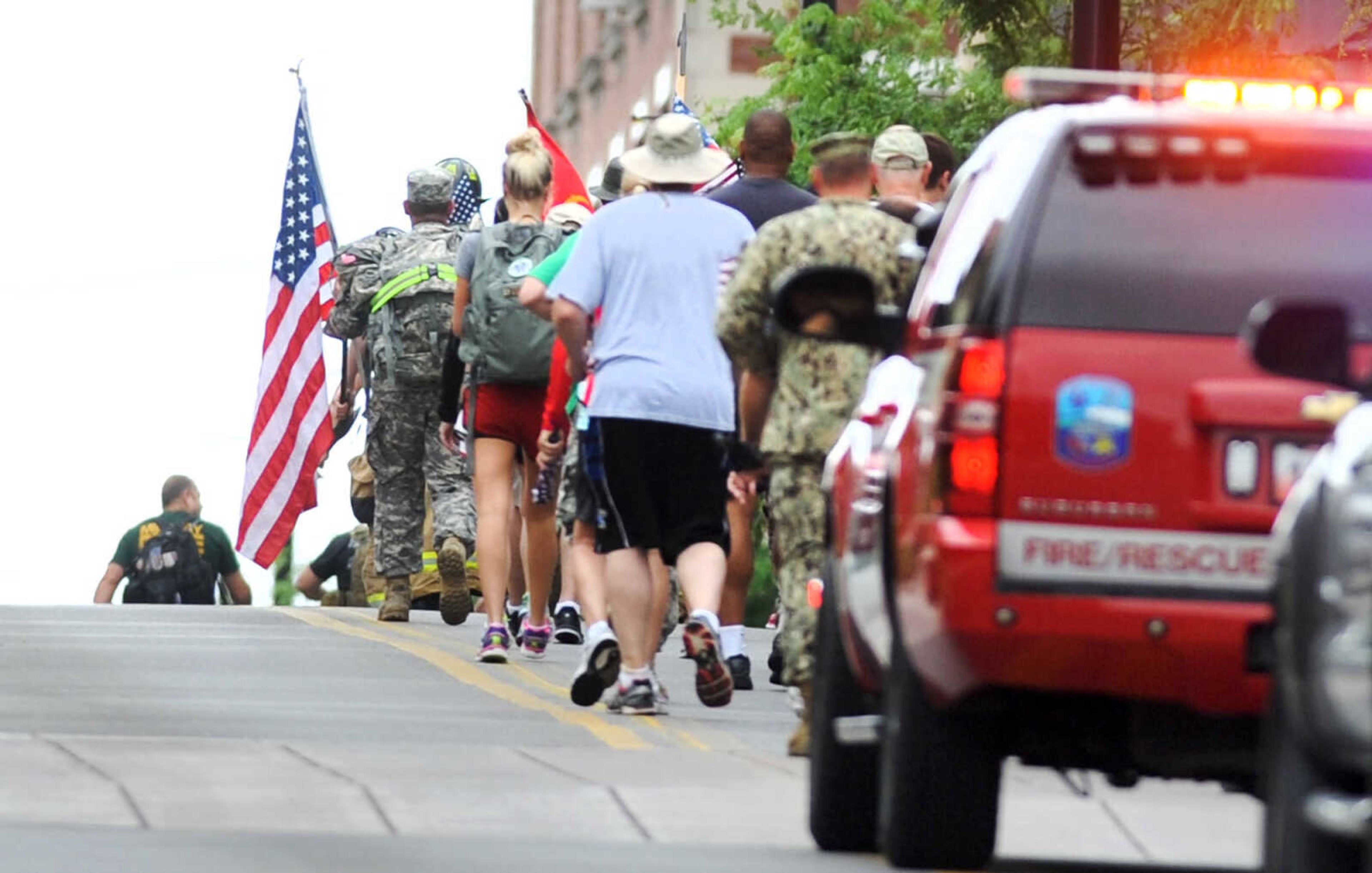 LAURA SIMON ~ lsimon@semissourian.com

Participants in the first ever Carry the Load event are escorted by members of the Cape Girardeau Fire Department as they begin their trek on Broadway, heading to Cape County Park North, Monday, May 25, 2015, in Cape Girardeau.