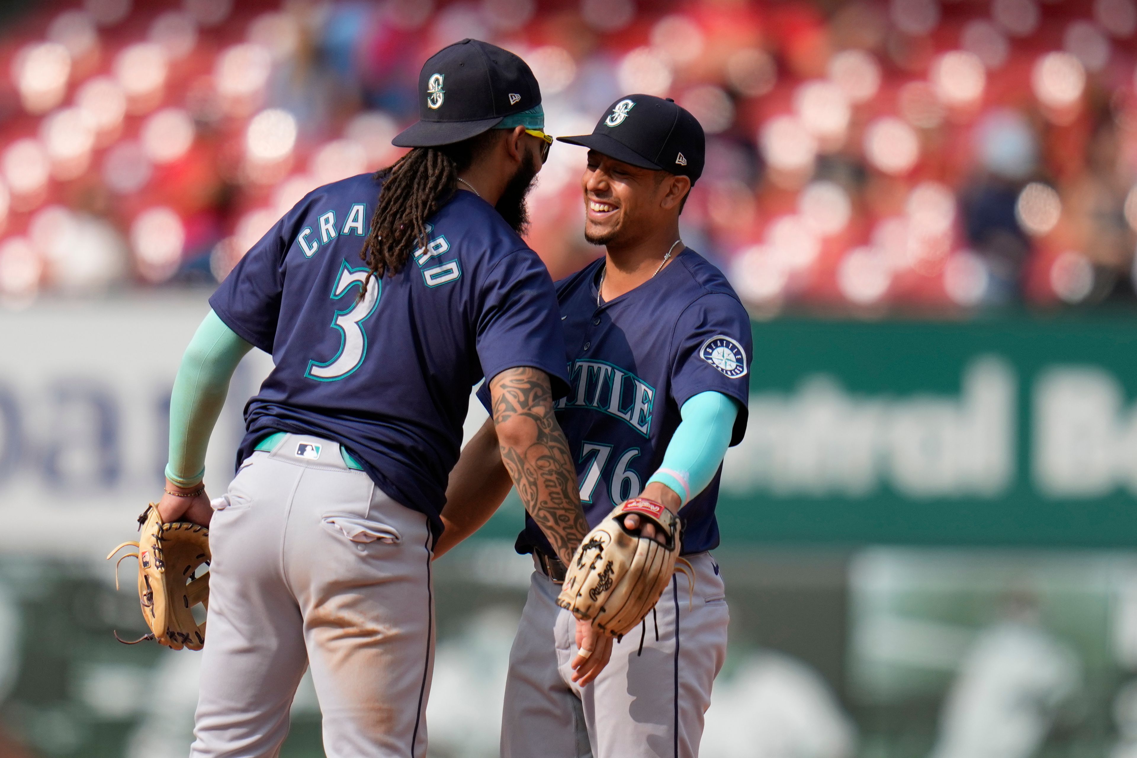 Seattle Mariners' J.P. Crawford (3) and Leo Rivas (76) celebrate a 10-4 victory over the St. Louis Cardinals following a baseball game Sunday, Sept. 8, 2024, in St. Louis. (AP Photo/Jeff Roberson)