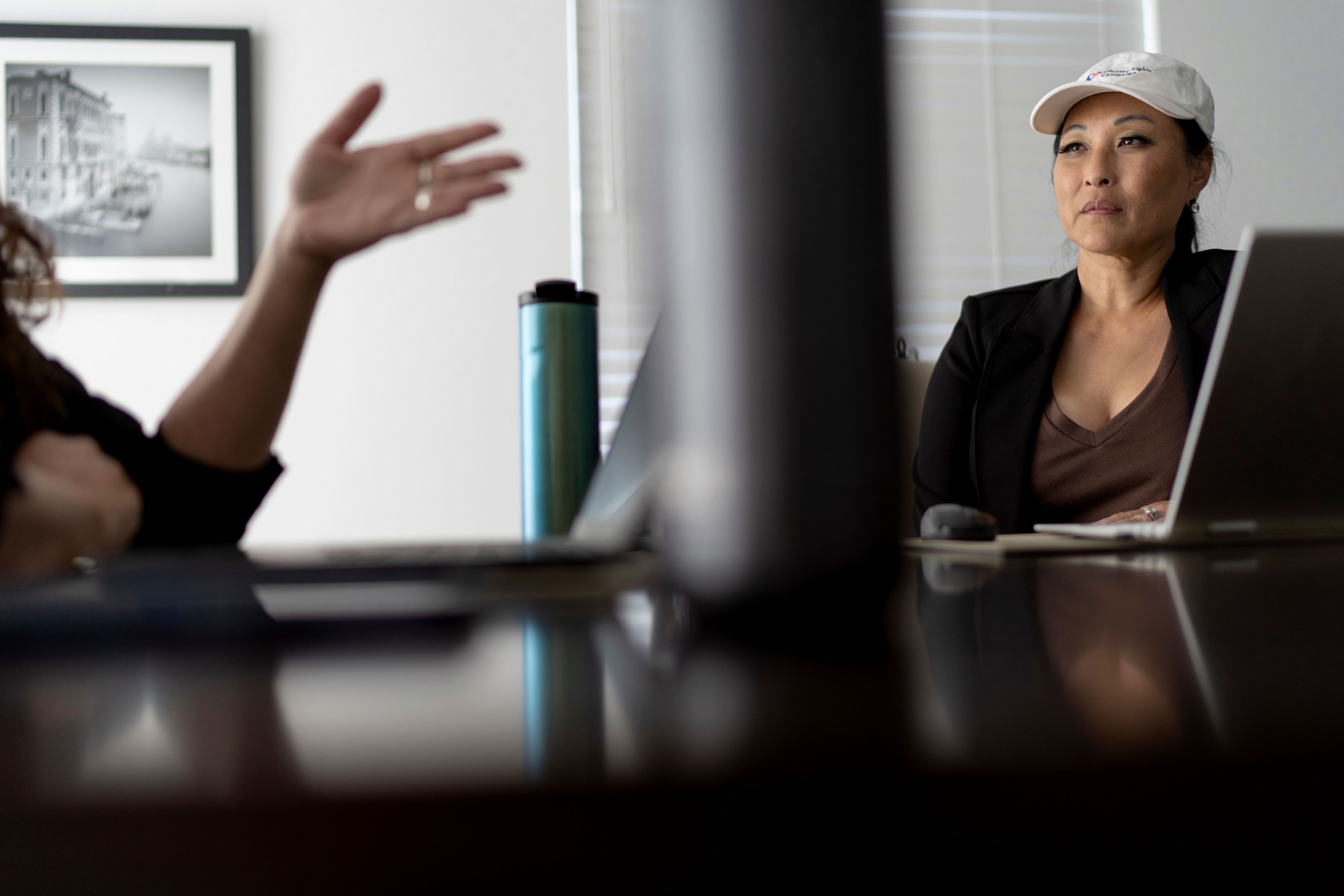 Joy Alessi, right, talks with Buttons, at Alessi's home Monday, June 24, 2024, in Henderson, Nev. They started the Adoptee Rights Campaign after their adoption as children from abroad by American parents left them without citizenship by loopholes in American law. (AP Photo/David Goldman)