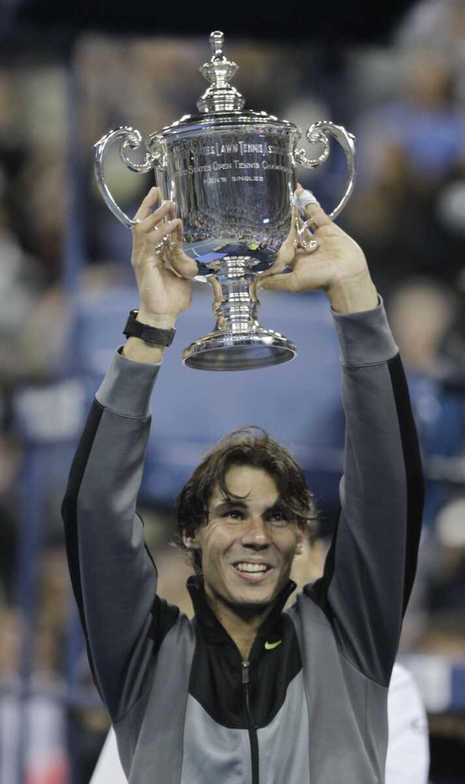 Rafael Nadal holds the championship trophy Monday after defeating Novak Djokovic in four sets to win the U.S. Open in New York. (Charles Krupa ~ Associated Press)