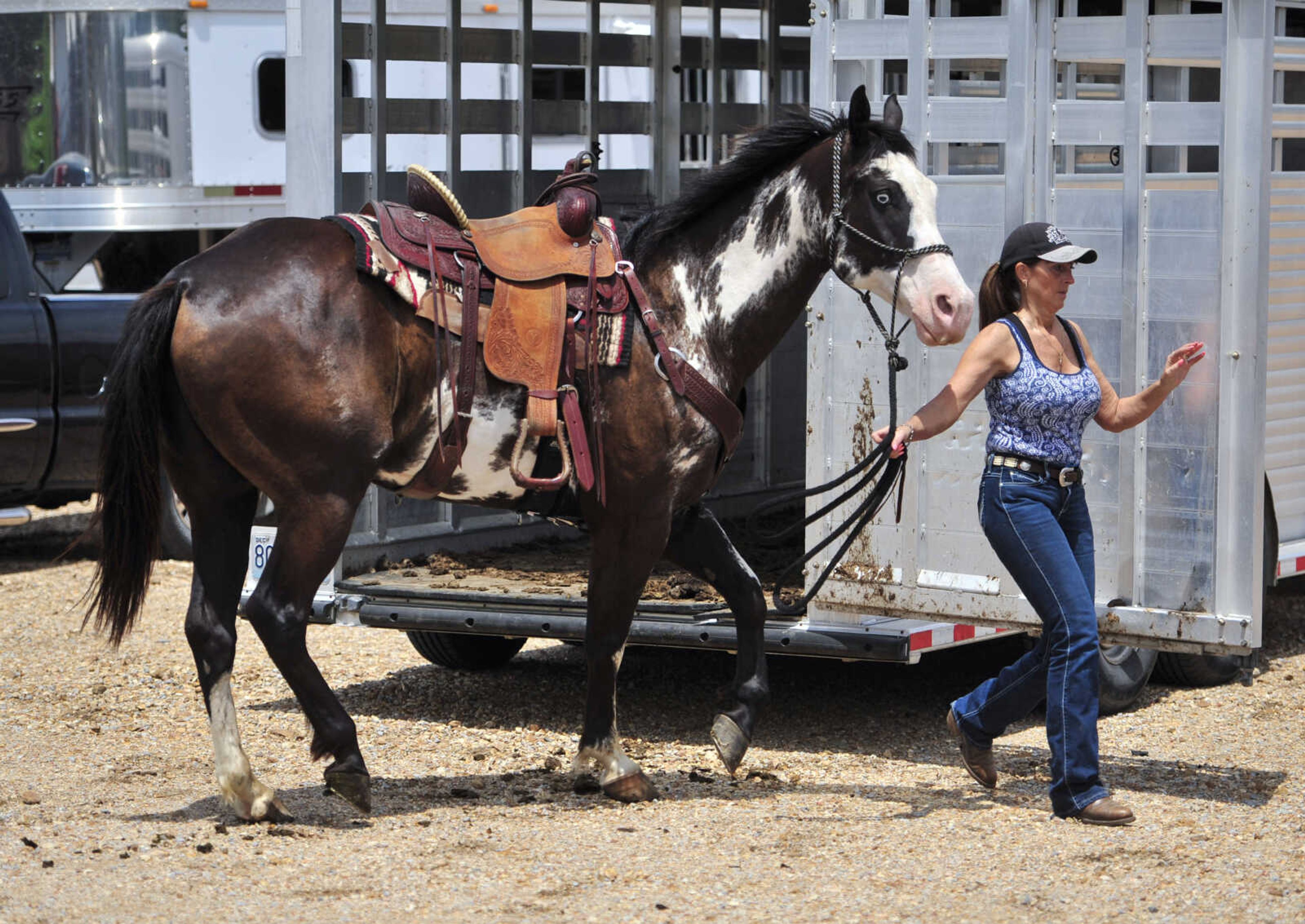 Tina McMahon escorts her quarter horse, Koda, out of her trailer June 4, 2017, in Patton, Missouri.