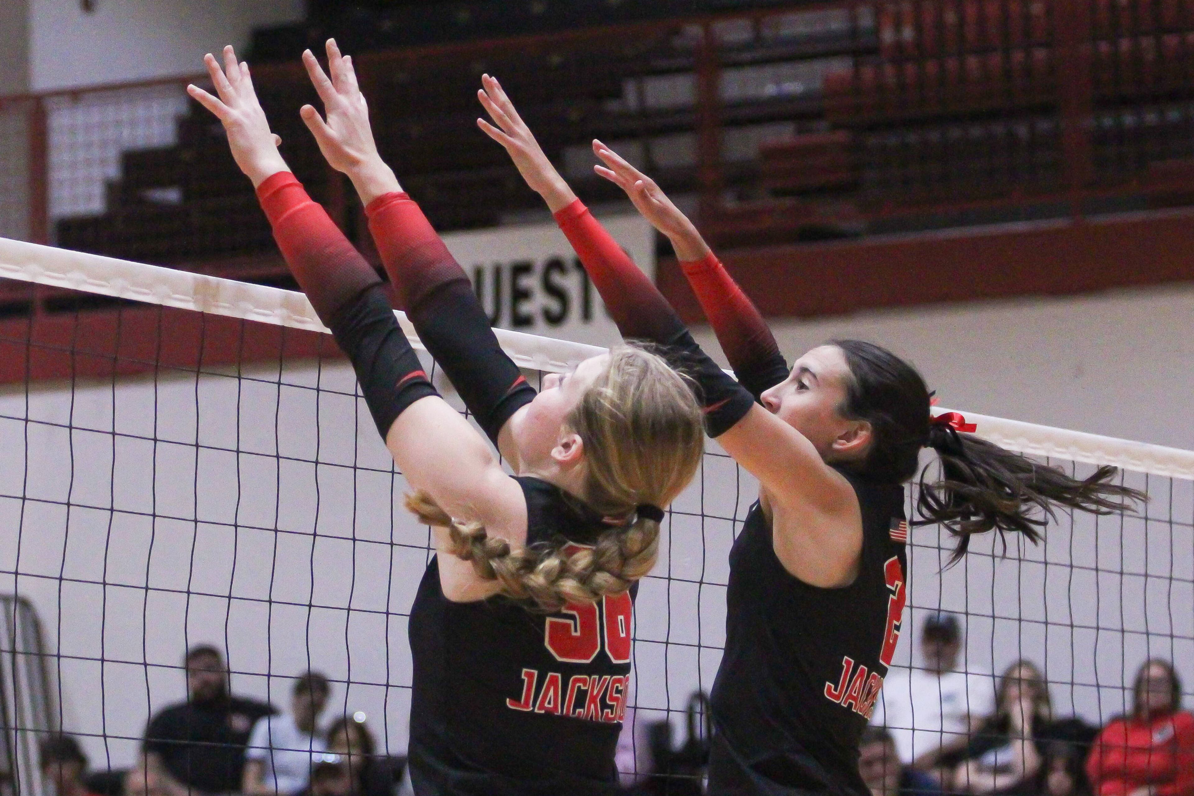 Jackson's Kateryna Elefson, left, and Lyla Sands set up a block during a game between the Jackson Indians and the Dexter Bearcats on Sept. 5 in Jackson.