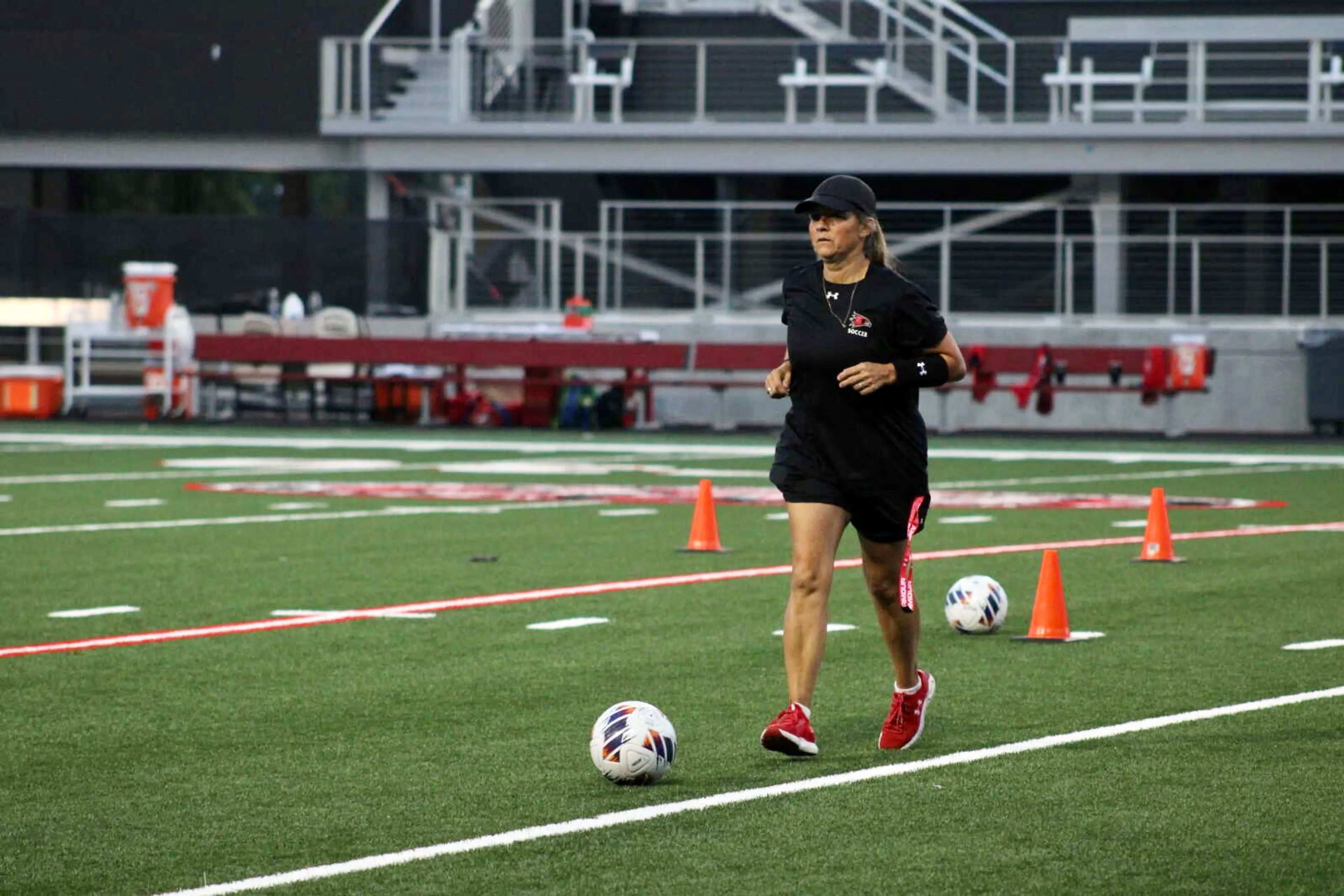 Southeast Missouri State coach Heather Nelson kicks a ball during a practice last year in Houck Field.