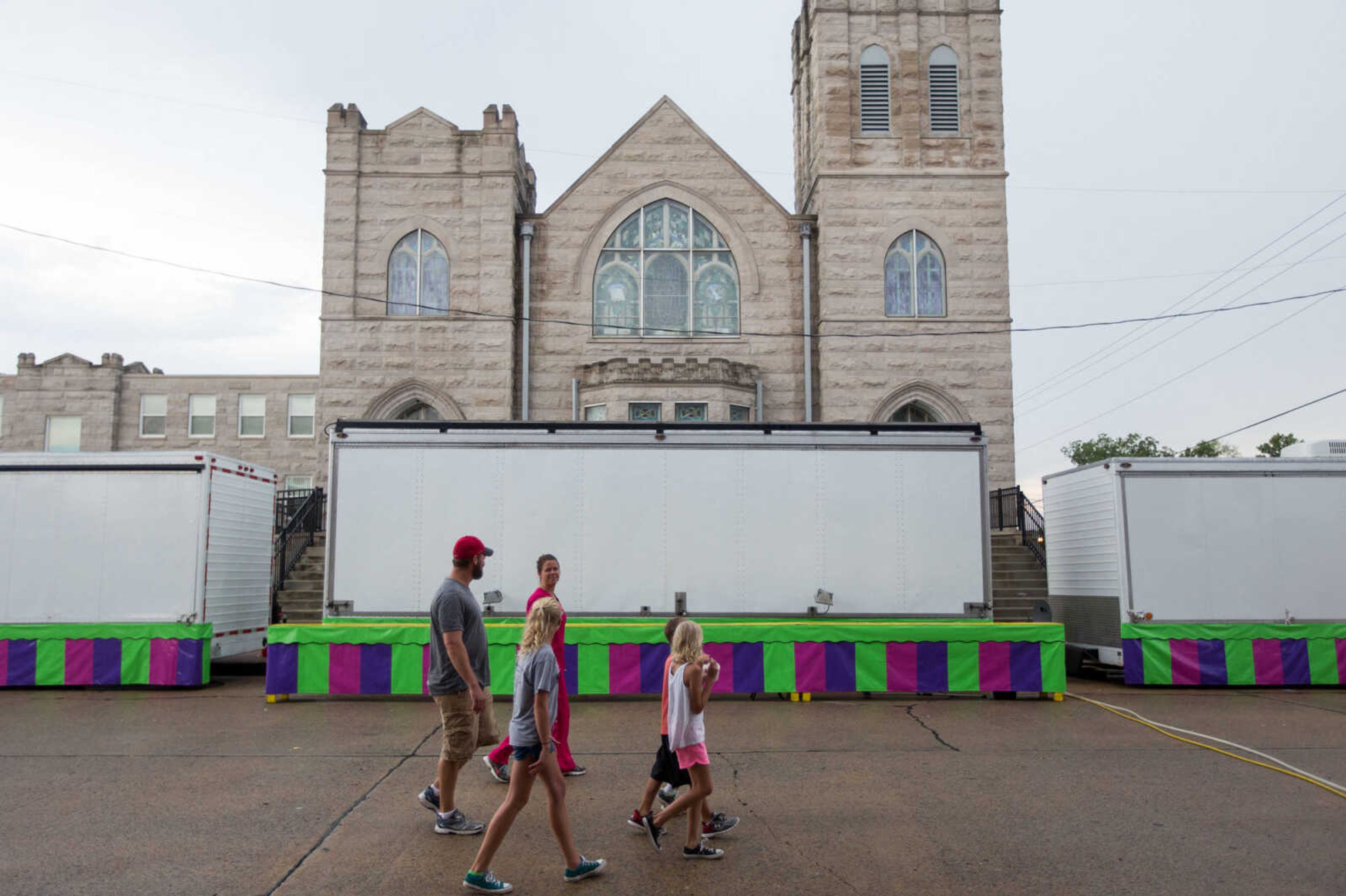 GLENN LANDBERG ~ glandberg@semissourian.com

A group of people make their way along South High Street during a rainy opening day of the 108th Homecomers in Jackson, Tuesday, July 26, 2016. Homecomers runs through Saturday in uptown Jackson.