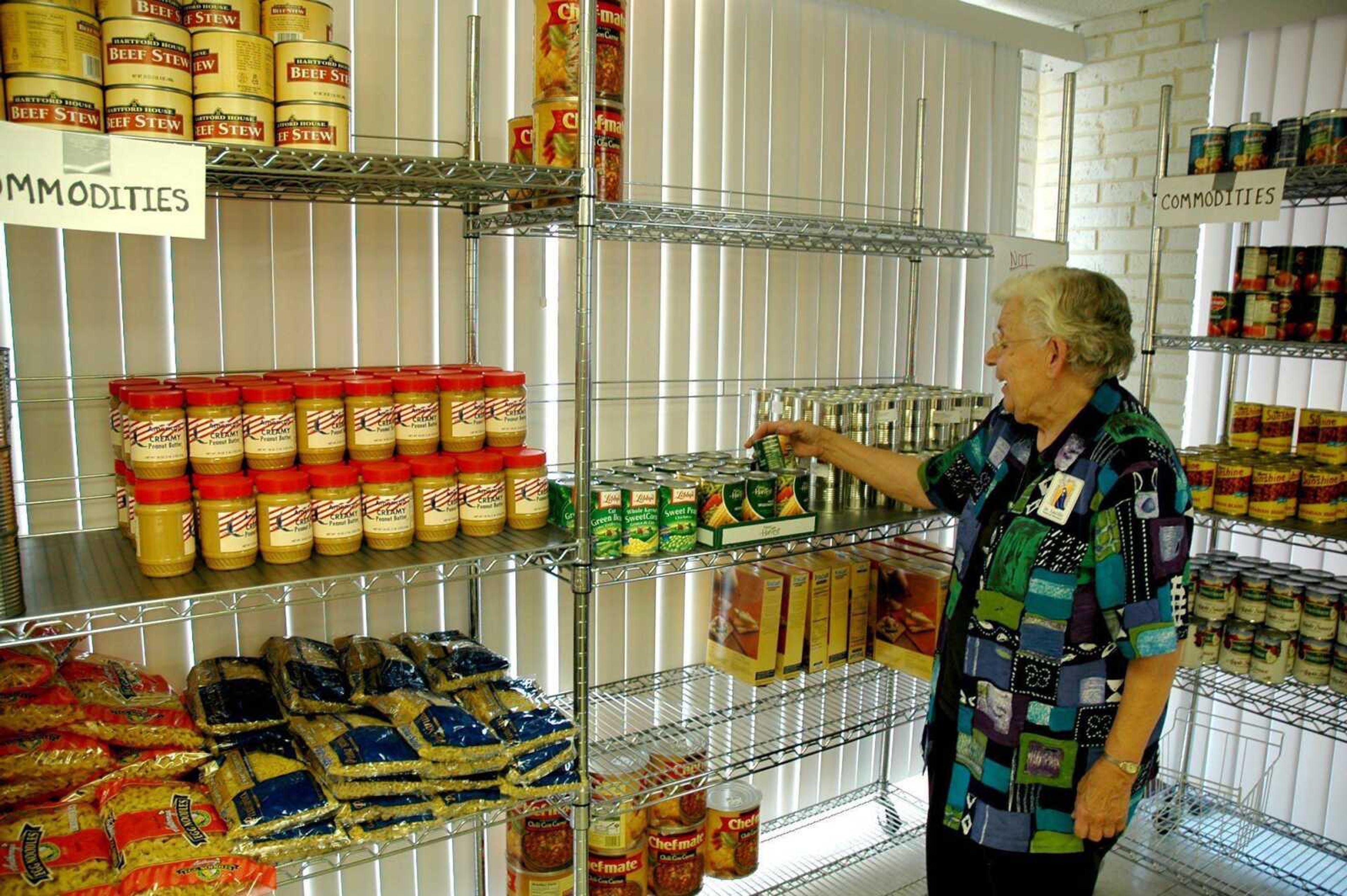 Sister Lucille Zerr is one of about 20 volunteers at the St. Mary Cathedral and Old St. Vincent Church Food Pantry who hosted an open house Saturday at its new facility at 134 S. Sprigg St. The pantry served 955 people last month and that number is expected to grow because the pantry's new location is more visible, said volunteer Donnie Shuck. The pantry was previously in a house on Spanish Street near Old St. Vincent. It began operating Aug. 31 at the new Sprigg Street facility and is open from 9 a.m. to 11 a.m. Tuesdays and Saturdays, serving more than 60 families each day, Shuck said. Both volunteers and donations are needed to keep up with the increasing needs, he said. In addition to the new pantry, the building is also home to a Catholic Charities of Southern Missouri Eastern Region office. Kyle Schott, a licensed professional counselor, has been named Eastern Region director and will offer case management and counseling services through Catholic Charities. While the office is in Cape Girardeau, Schott will serve Cape Girardeau, Bollinger, northern Scott and Madison counties. (Melissa Miller)