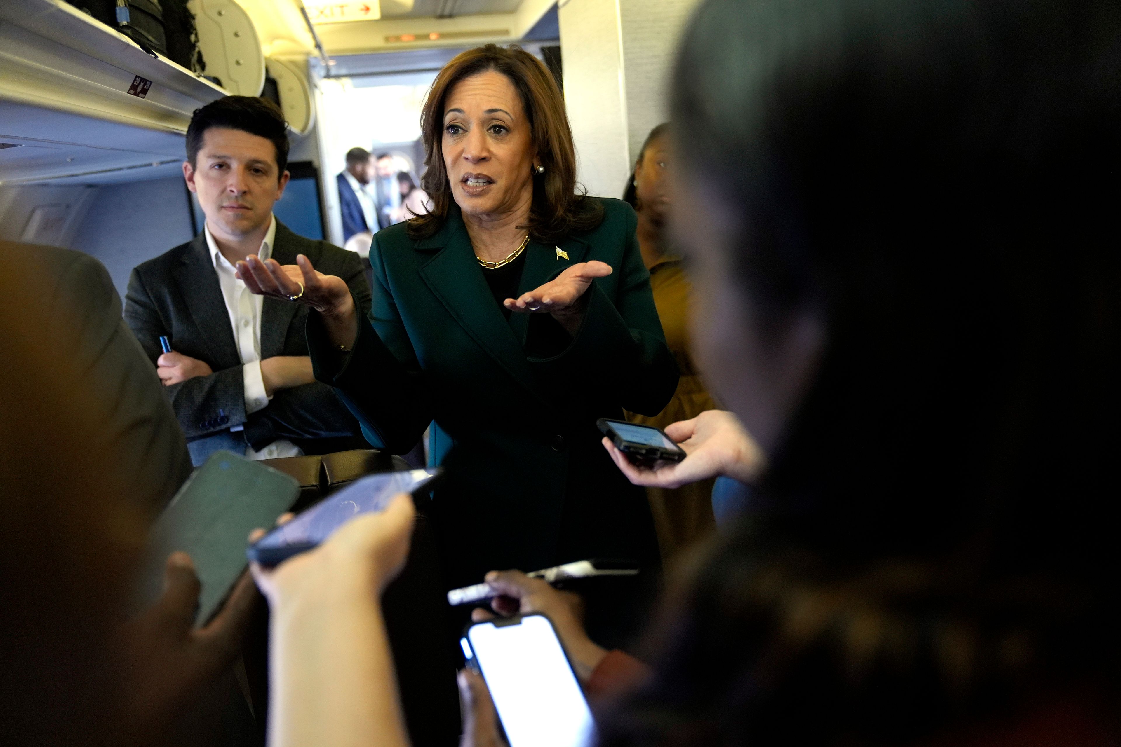 Democratic presidential nominee Vice President Kamala Harris speaks with members of the press on board Air Force Two at Philadelphia International Airport, Monday, Oct. 21, 2024, in Philadelphia, before departing to Michigan. (AP Photo/Jacquelyn Martin, Pool)