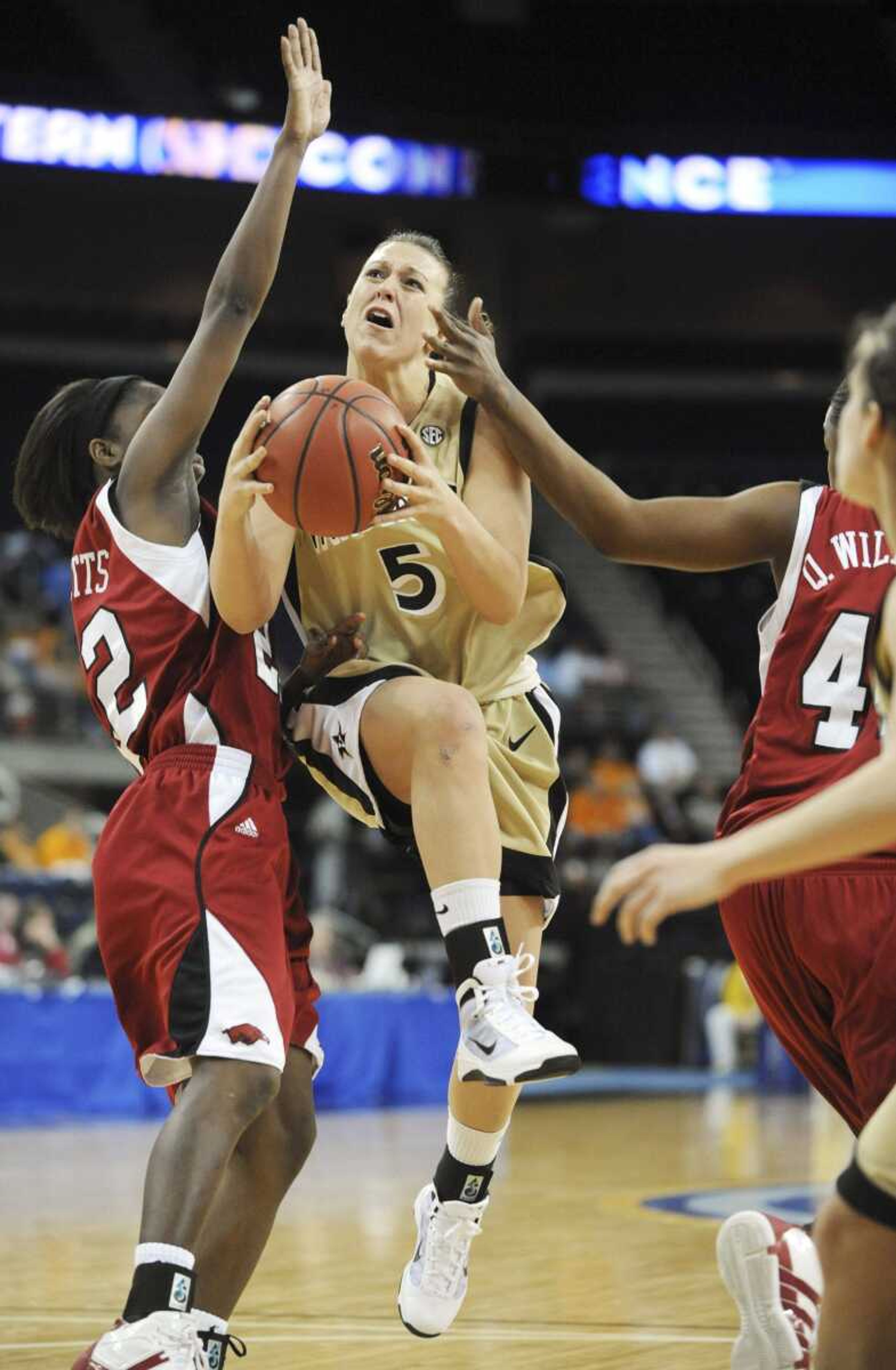 Vanderbilt guard Lauren Lueders splits the Arkansas defense during their Southeastern Conference tournament game earlier this month. (ERIK LESSER ~ Associated Press)