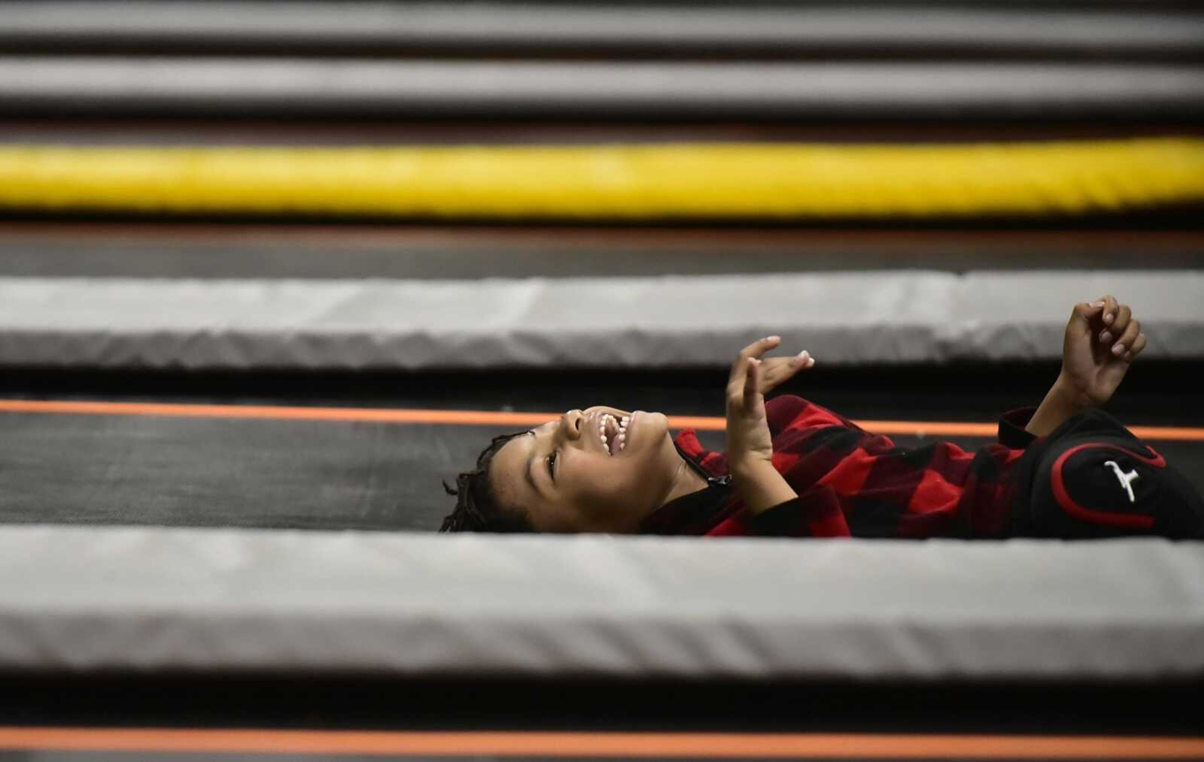 Linny Reid, 6, laughs while playing on a trampoline Tuesday, Feb. 13, 2018, during an Easterseals Midwest monthly outing at Ultimate Air Trampoline Park in Scott City.