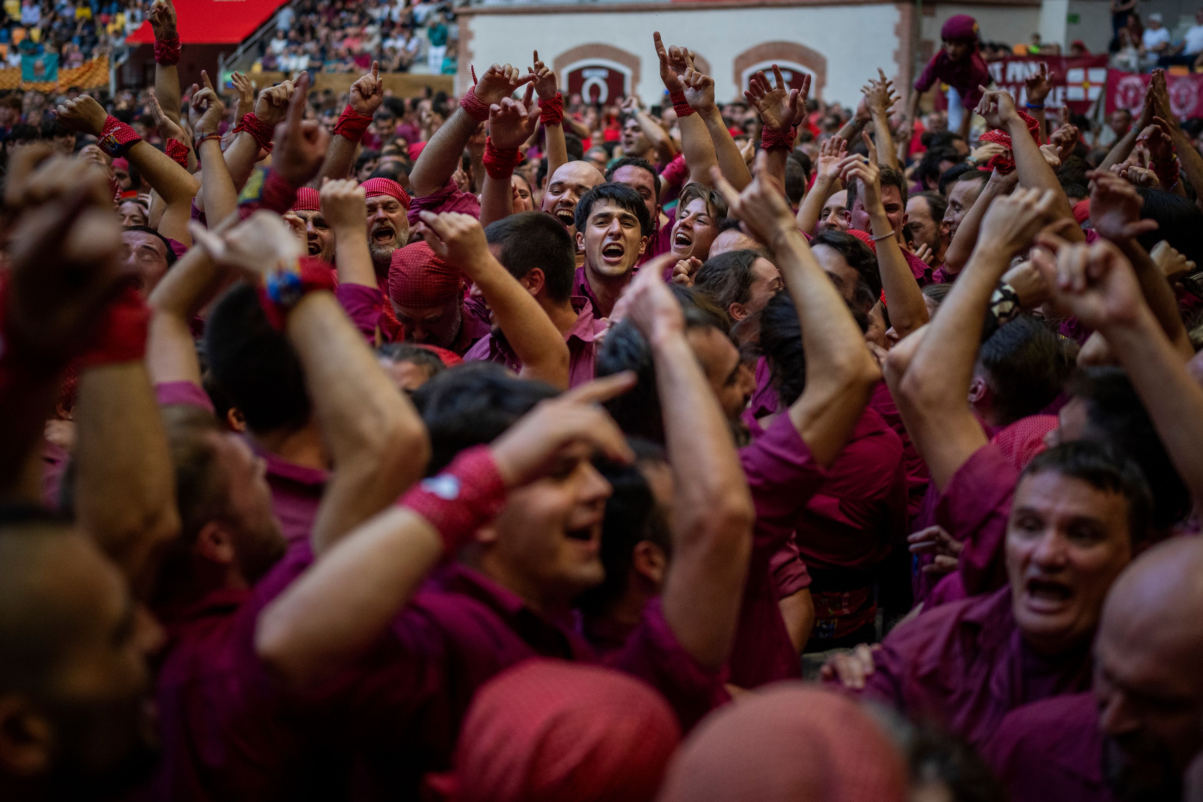 Members of "Castellers de Lleida" celebrate after successfully completing a "castells" or human tower, during the 29th Human Tower Competition in Tarragona, Spain, Saturday, Oct. 5, 2024. (AP Photo/Emilio Morenatti)