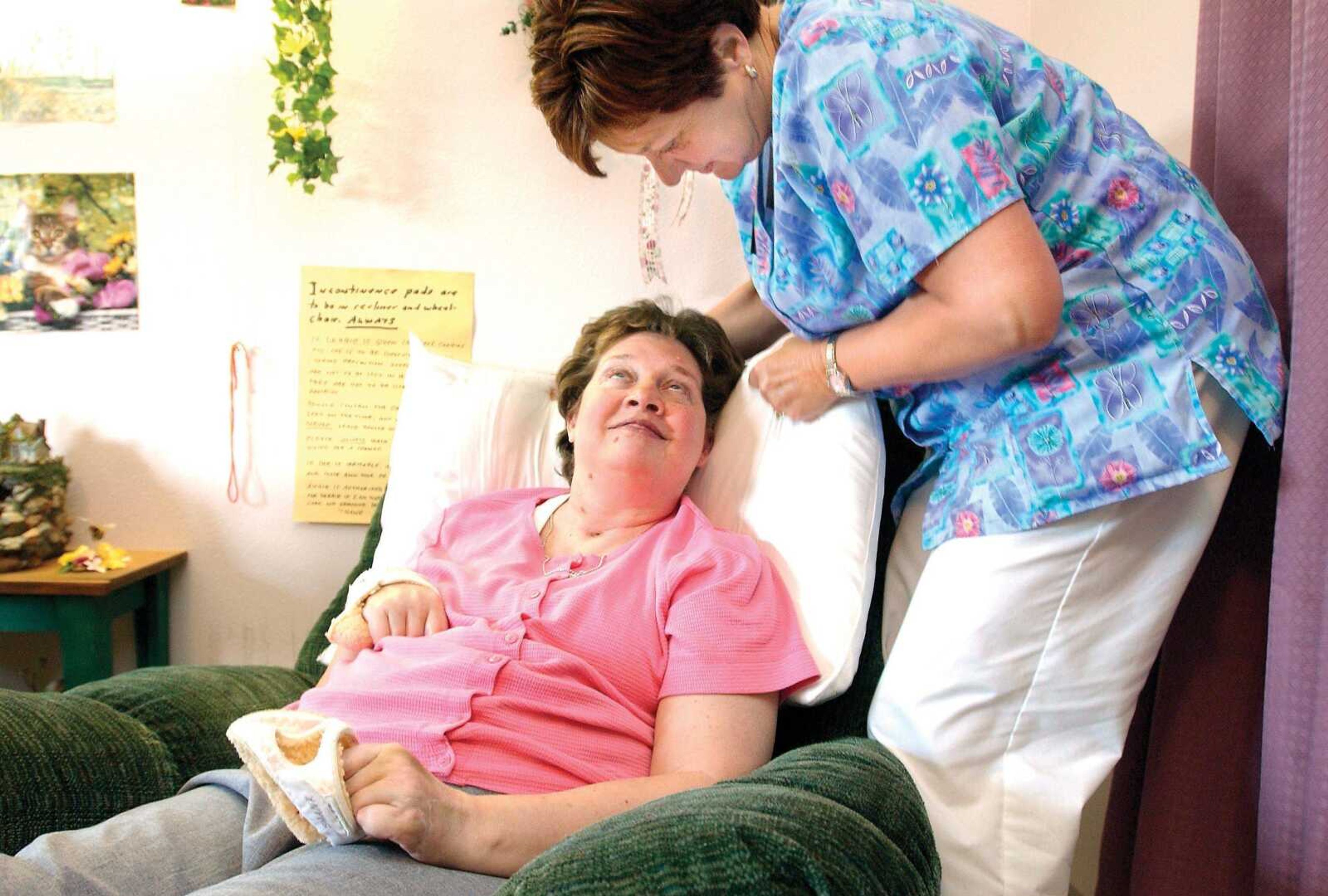 Debbie Shank, left, disabled by injuries caused in an automobile accident, gave nurse Rickie Scott, director of nursing for Monticello House in Jackson, a big smile in this 2005 photo. (Southeast Missourian file)