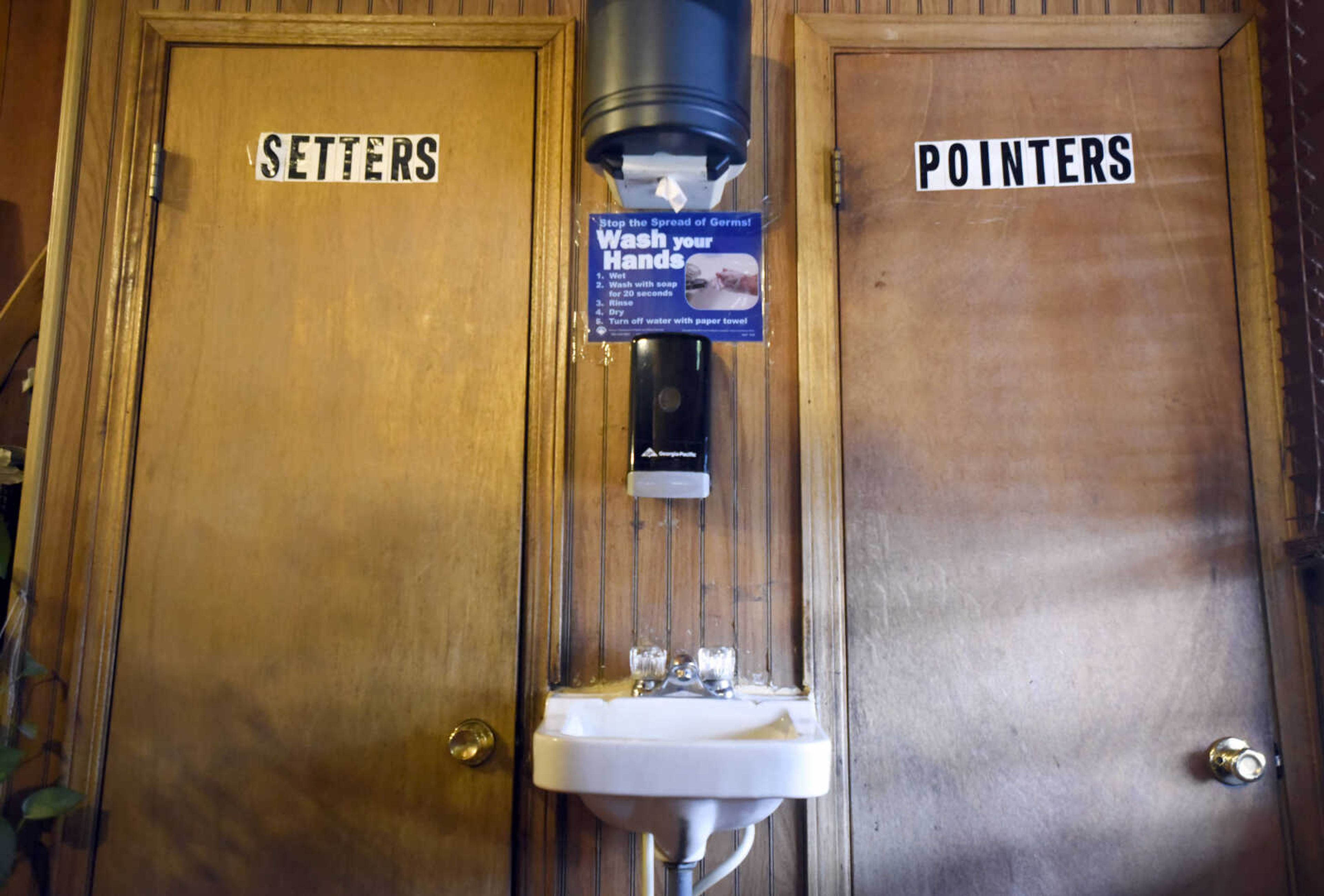 The cheeky bathroom doors at Al's Place in McBride, Missouri.