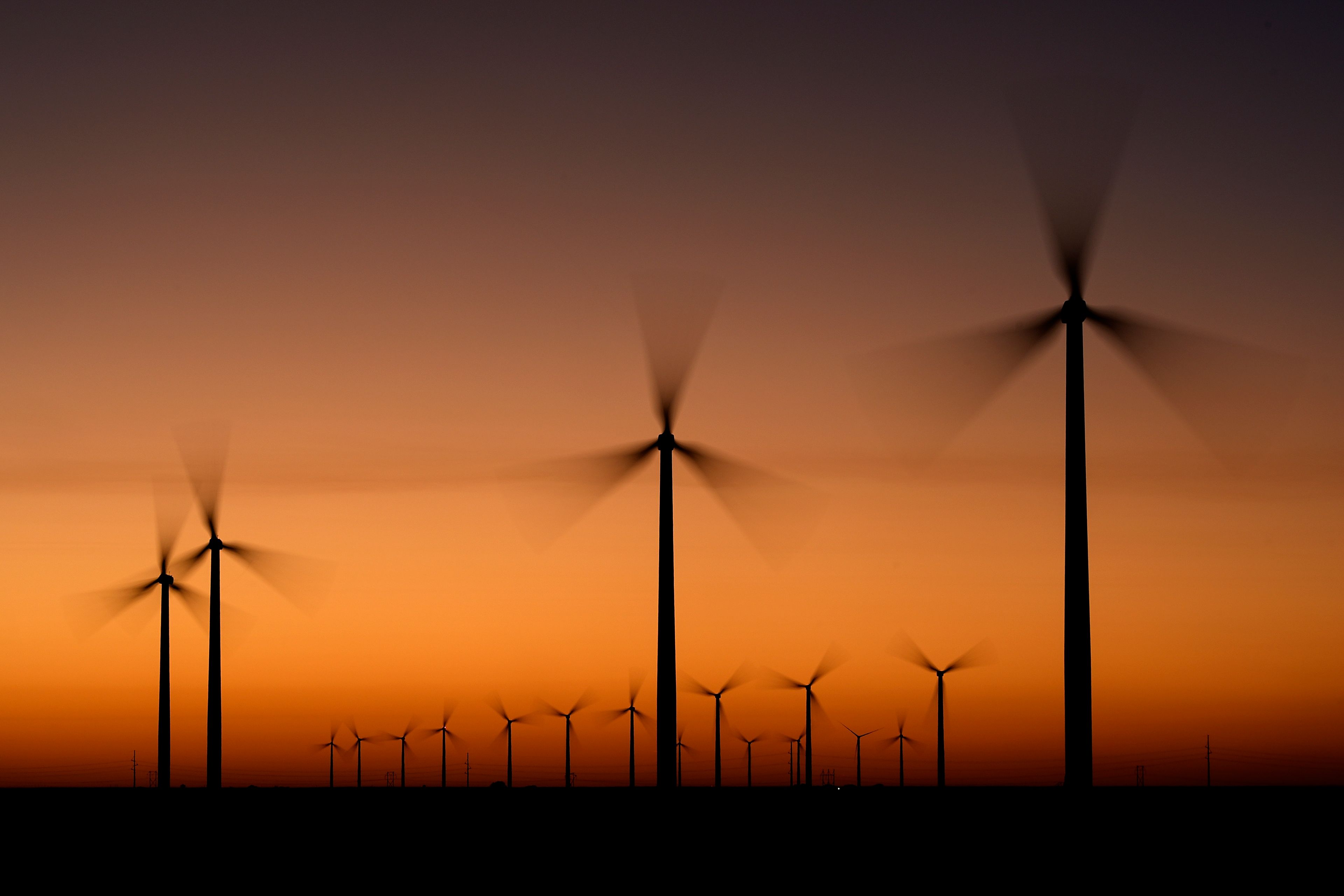 Wind turbines stretch across the horizon at dusk at the Spearville Wind Farm, Sunday, Sept. 29, 2024, near Spearville, Kan. (AP Photo/Charlie Riedel)