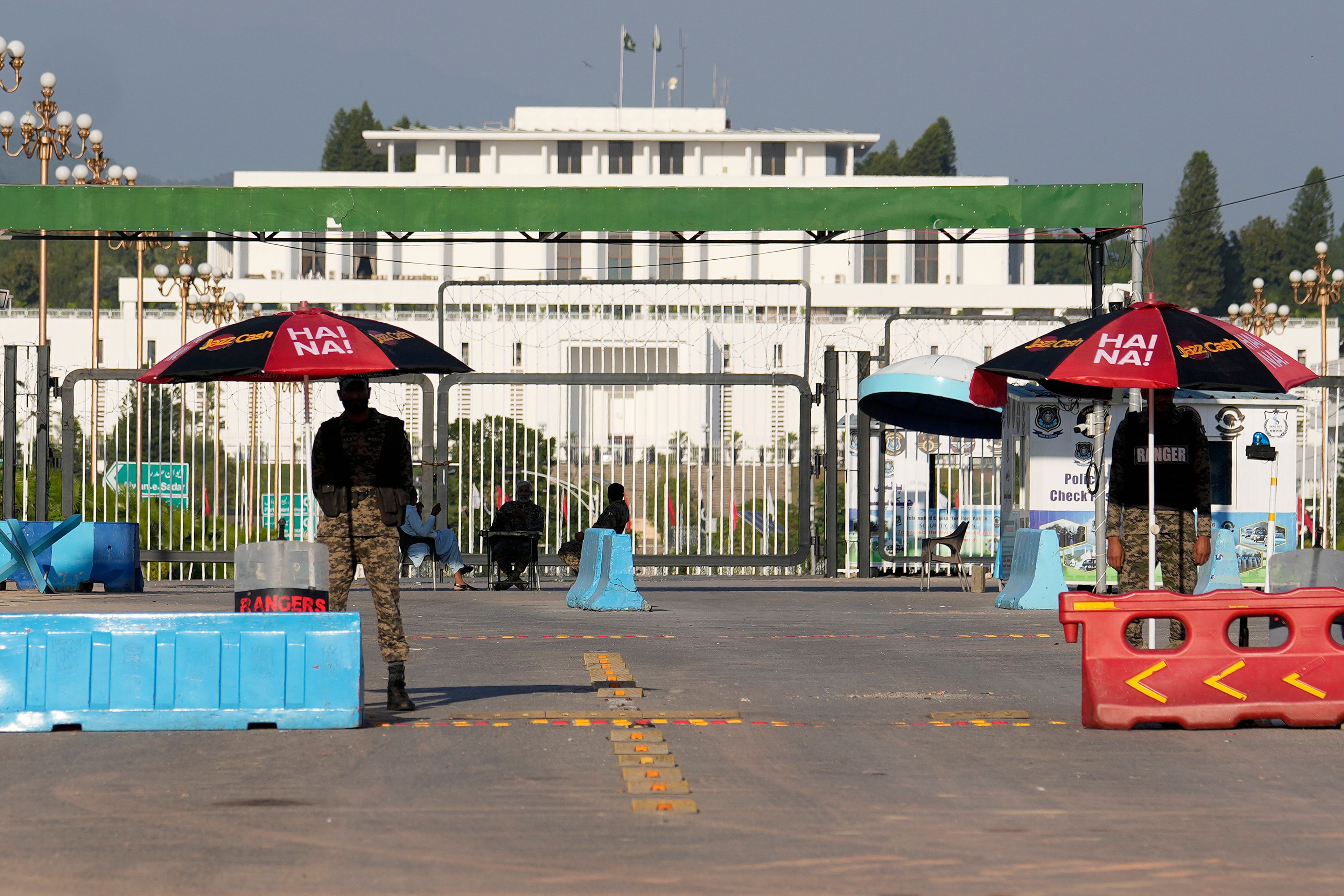 Paramilitary soldiers stand guard at a barricaded road leading to Presidency, in background, and to the venue of the upcoming Shanghai Cooperation Organization (SCO) summit in Islamabad, Pakistan, Sunday, Oct. 13, 2024. (AP Photo/Anjum Naveed)