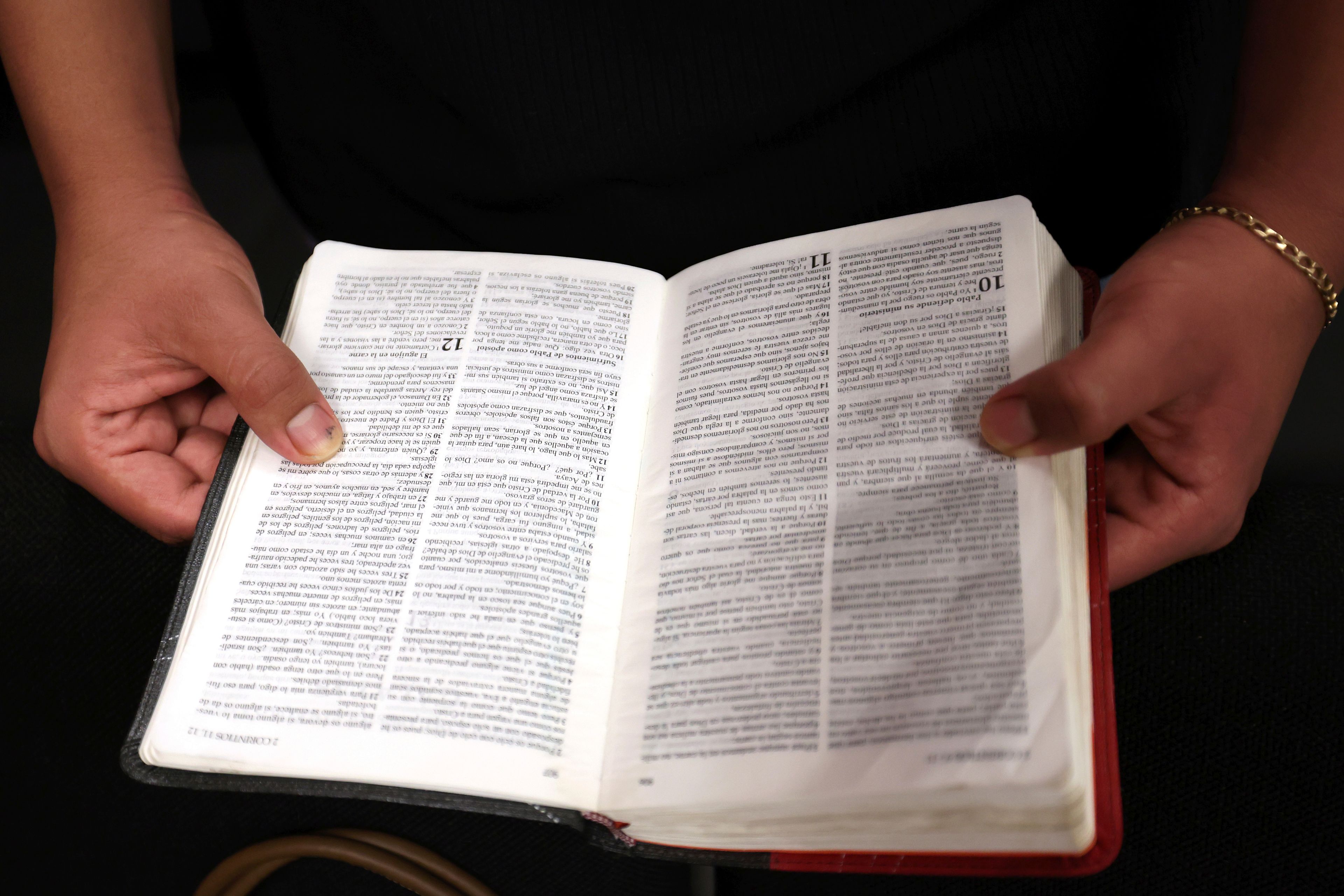 A worshipper holds a bible during services at Casa de Adoracion, Sunday, Oct. 27, 2024 in Phoenix. (AP Photo/Chris Coduto)