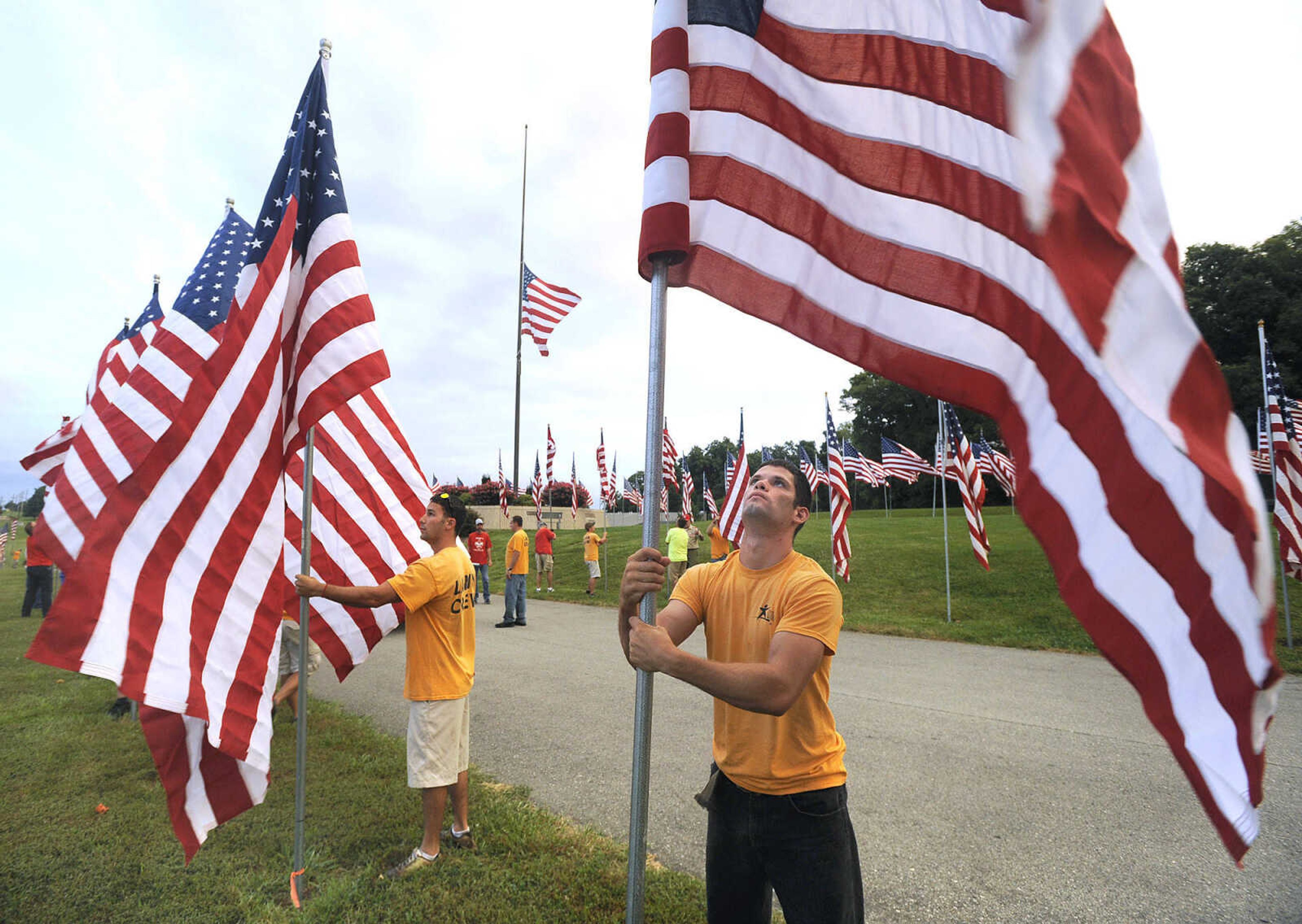 FRED LYNCH ~ flynch@semissourian.com
Kevin Phipps, a volunteer with Teen Challenge, helps set up the Avenue of Flags display in recognition of Patriot Day, Friday, Sept. 11, 2015 at Cape County Park North. More than 450 flags honored deceased Cape Girardeau County veterans.