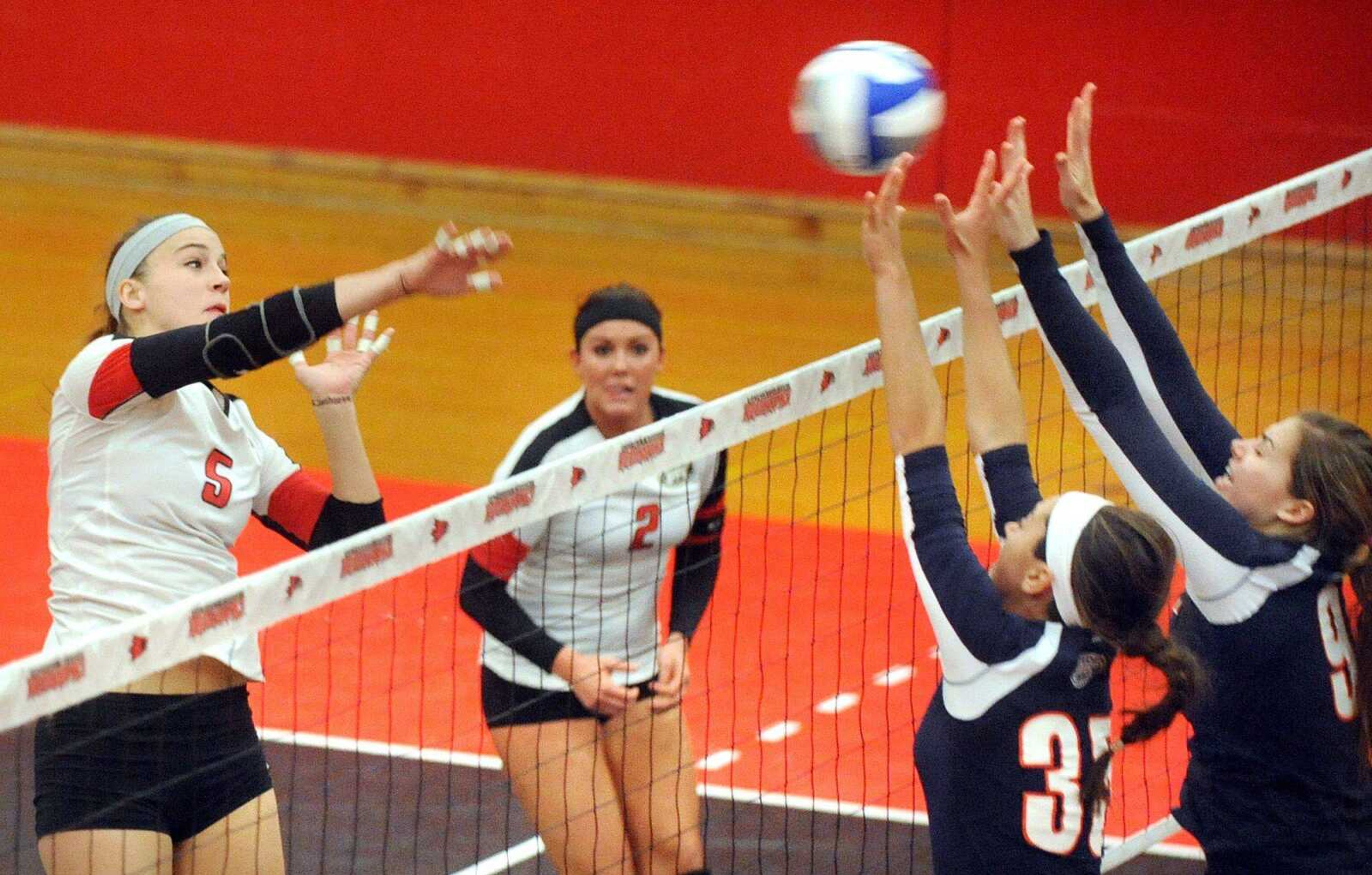 Southeast Missouri State's Emily Coon hits the ball into Tennessee-Martin blockers Madison Wessling, second from right, and Julia Devinney during the first game of Tuesday's match against the Skyhawks at Houck Field House. (Laura Simon)