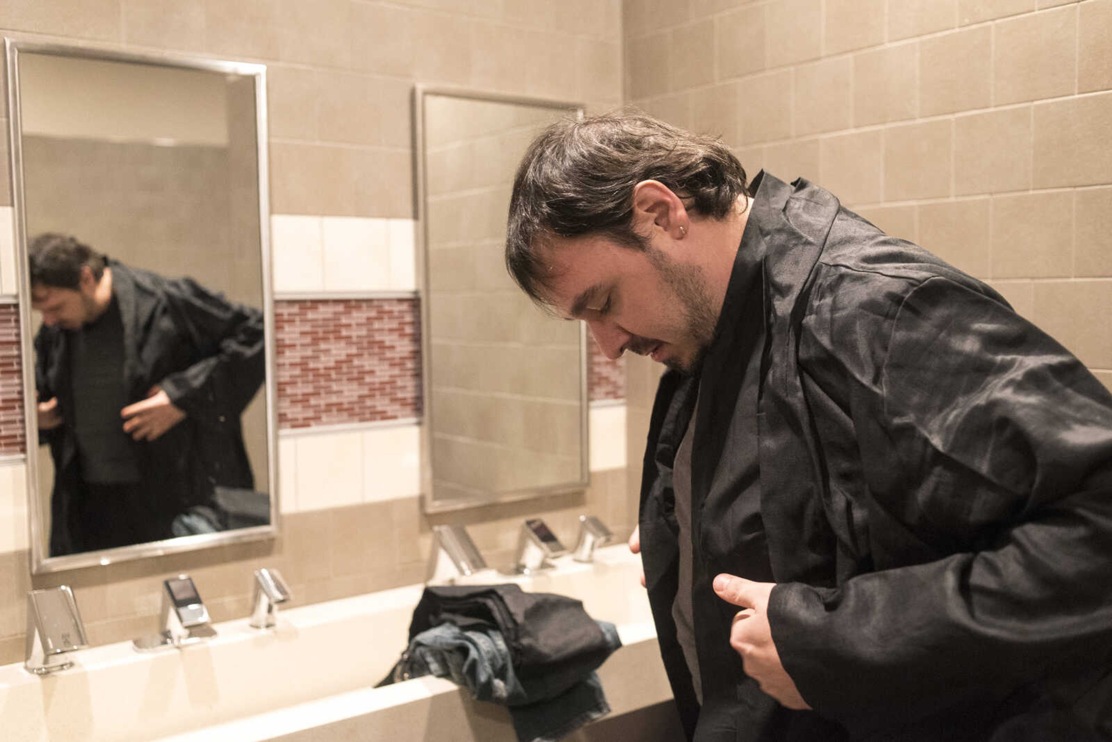 Elias Raley with the Southern Illinois Jedi Order gets ready in the bathroom before the showing of Star Wars: The Last Jedi Thursday, Dec. 14, 2017 at Cape West Cinema in Cape Girardeau.