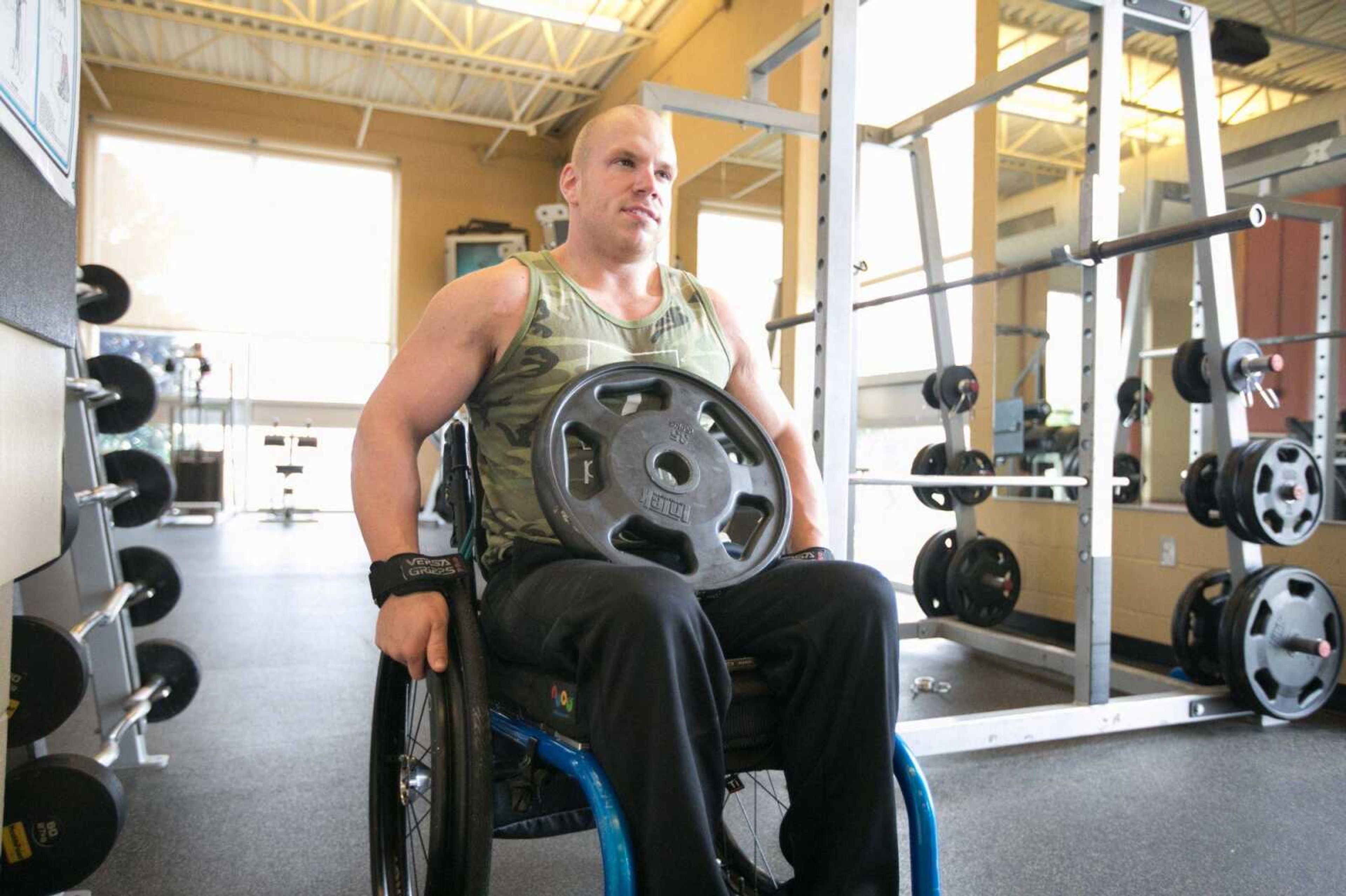 Brandon Strop grabs a 35-pound plate for additional weight during his workout routine Tuesday in Cape Girardeau. (Glenn Landberg)