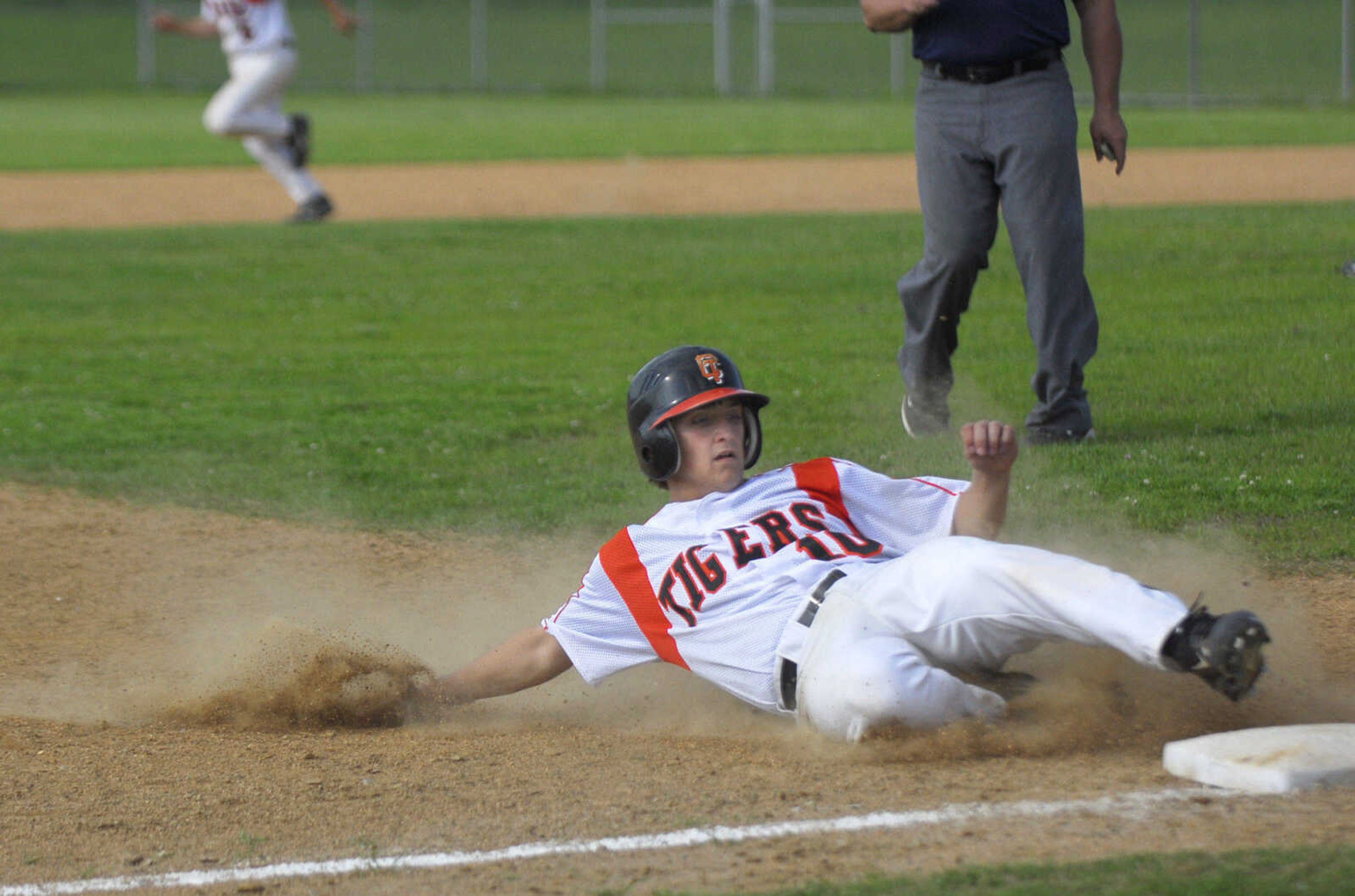 Blake Smith safely reaches third base Monday, May 11, 2009, at Central High in Cape Girardeau.