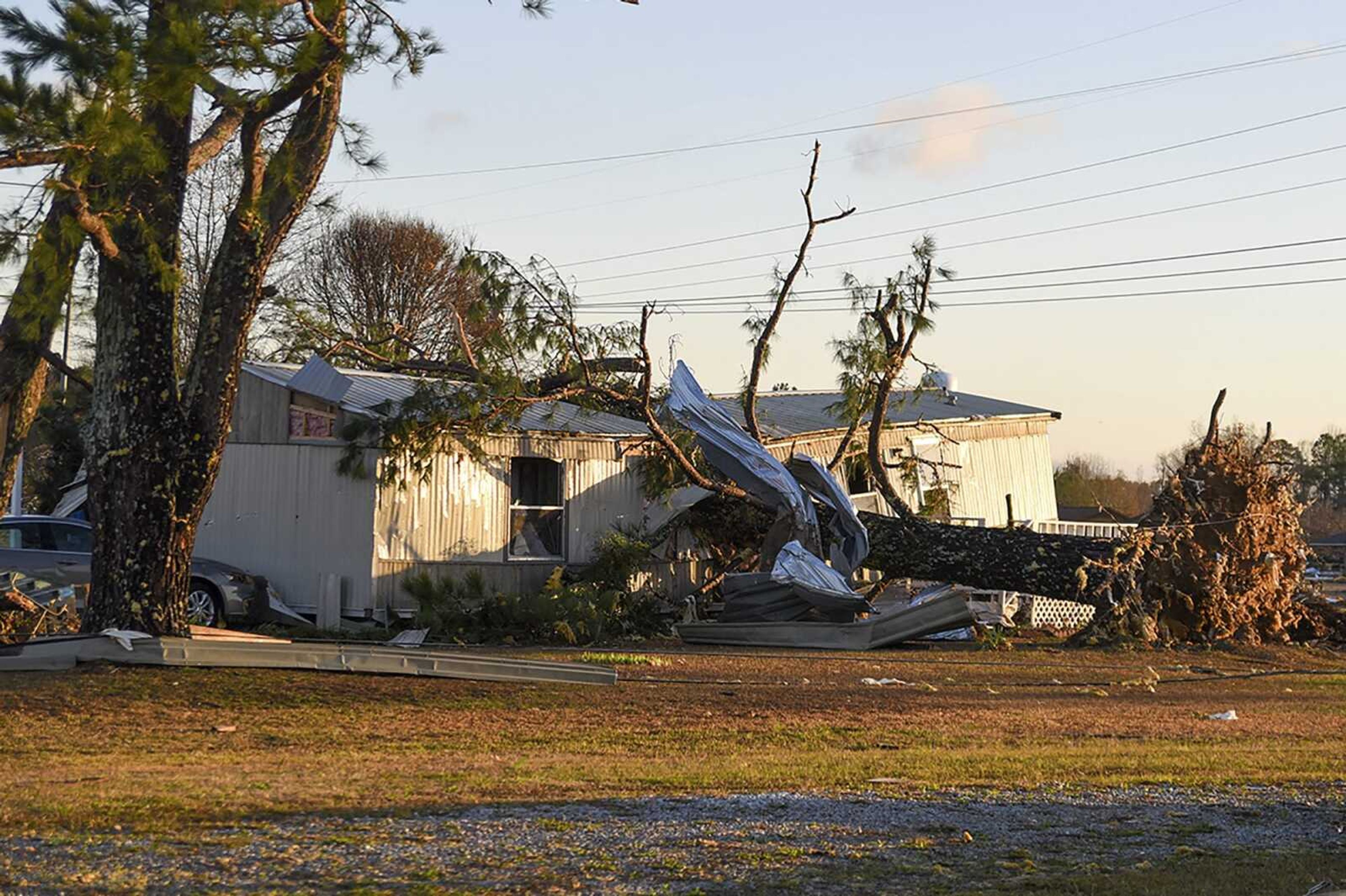 A tree lies on a mobile home on Cal-Steens Road in Lowndes County, Wednesday morning, Nov. 30, 2022, after a series of storms came through the area Tuesday night and early Wednesday morning. No injuries were reported. (Deanna Robinson/The Commercial Dispatch via AP)