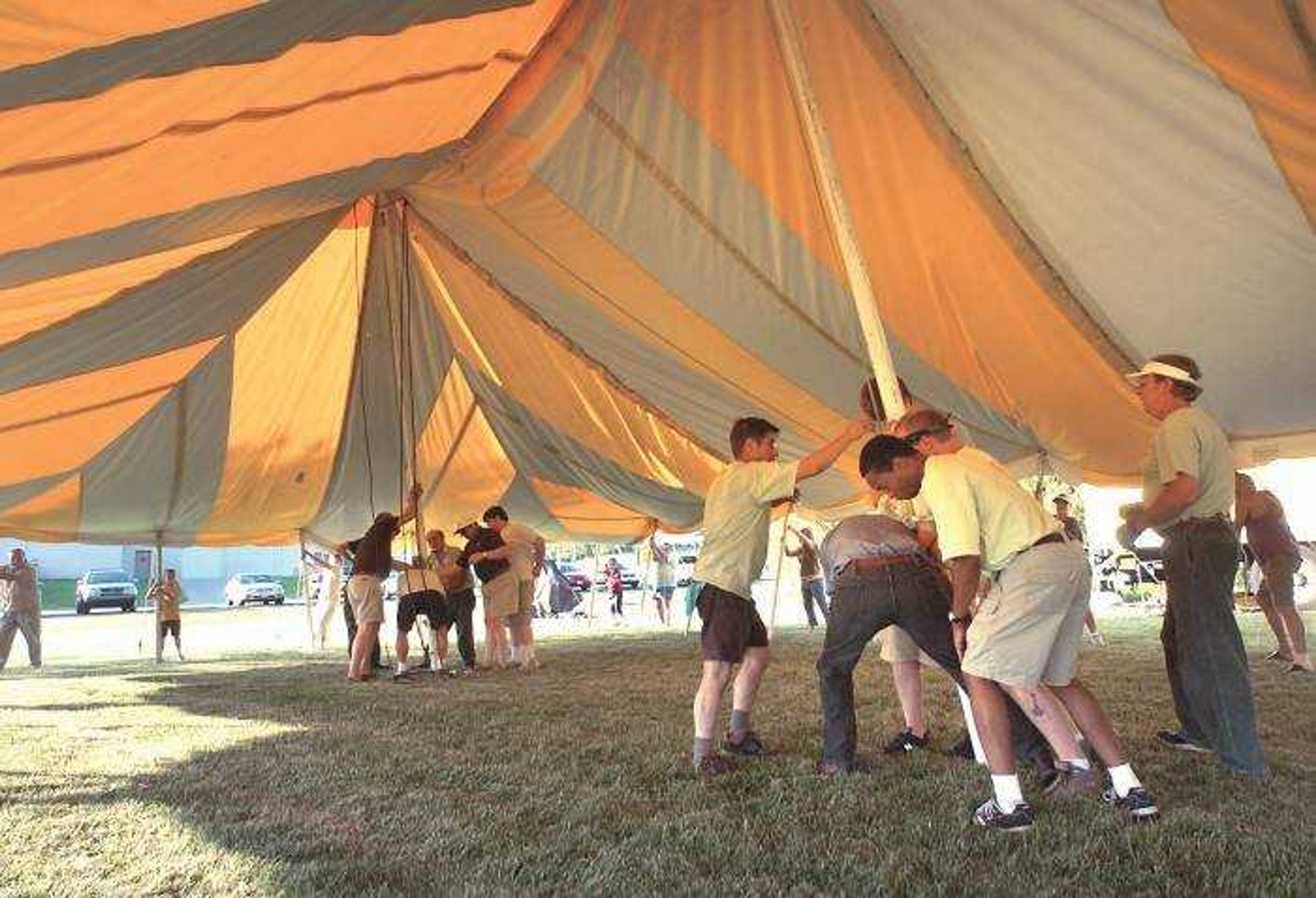 Chautauqua performers and support crew guided local residents Monday evening in raising the tent for the week-long cultural festival behind the Osage Community Centre. (Fred Lynch)