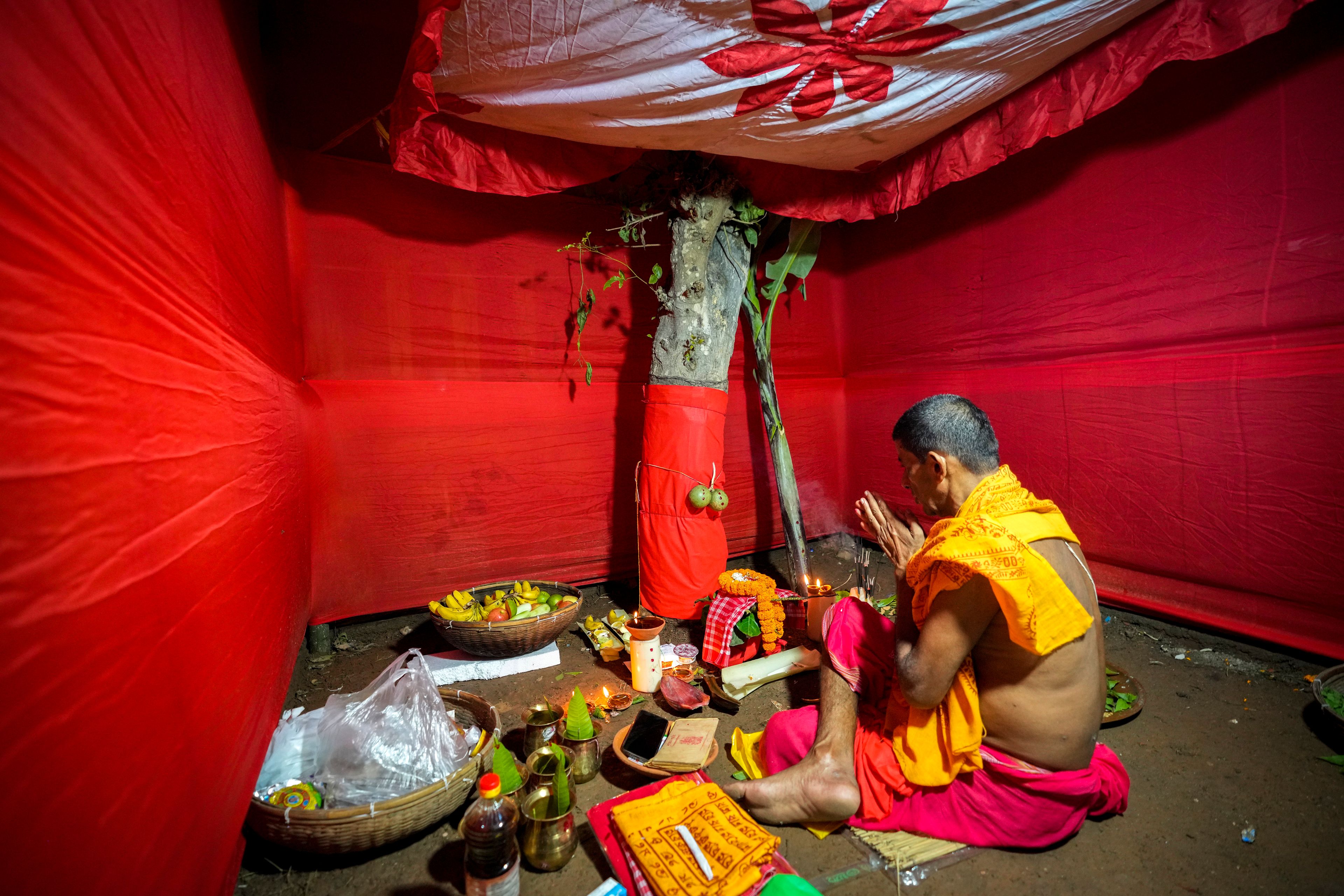 A Hindu priest performs ritual prayers before receiving an idol of the Hindu goddess Durga during the Durga Puja festival in Guwahati, India, Wednesday, Oct. 9, 2024. (AP Photo/Anupam Nath)