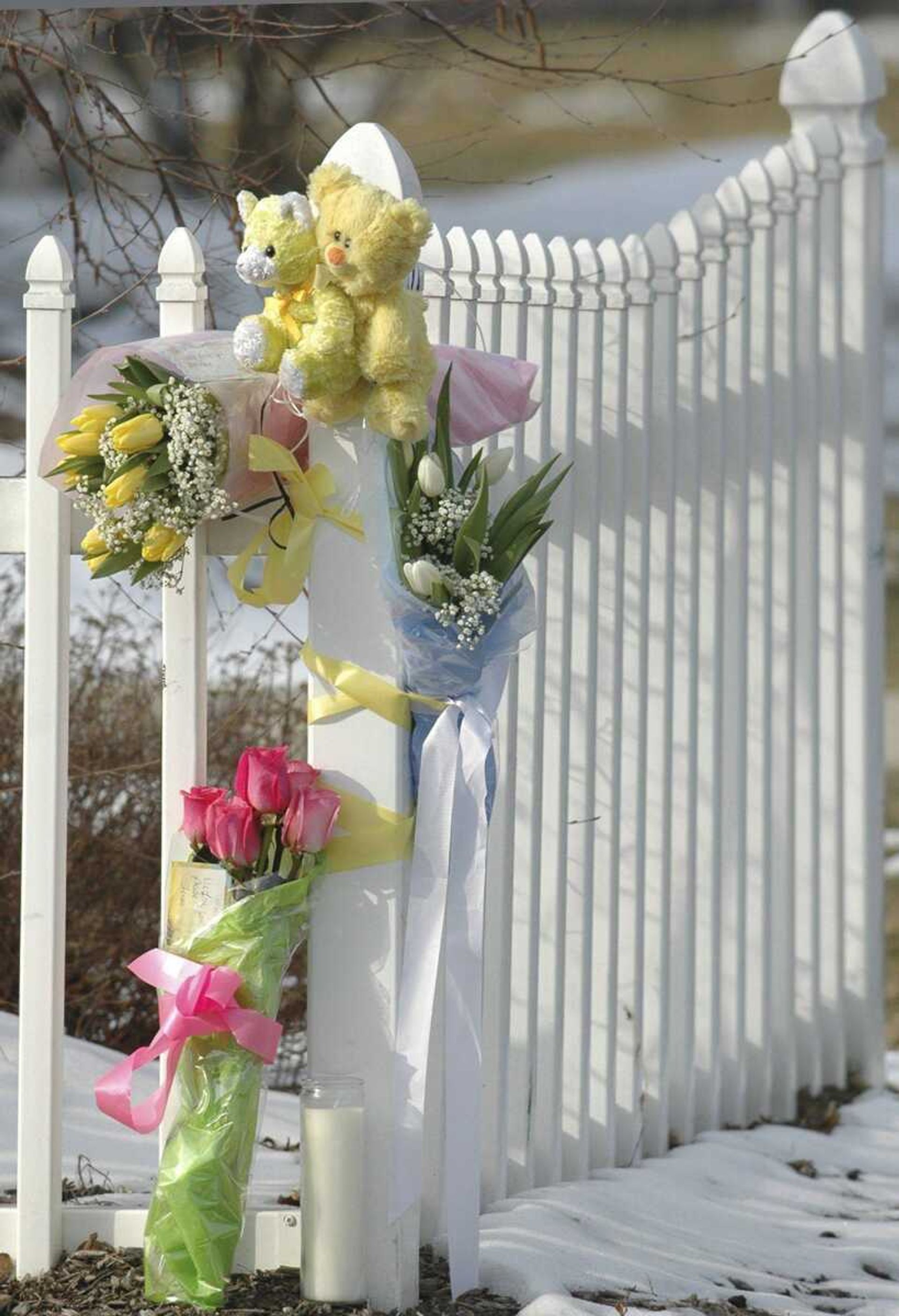 In this Jan. 15, 2010 photo, flowers are attached to a fence outside the home in South Hadley, Mass., where Phoebe Prince, 15, originally from Ireland, had killed herself the previous day. On Monday, March 29, 2010, nine teens were charged in the "unrelenting" bullying of Phoebe Prince, who killed herself after being raped and enduring months of torment by classmates in person and online. (AP Photo/The Republican, Dave Roback)