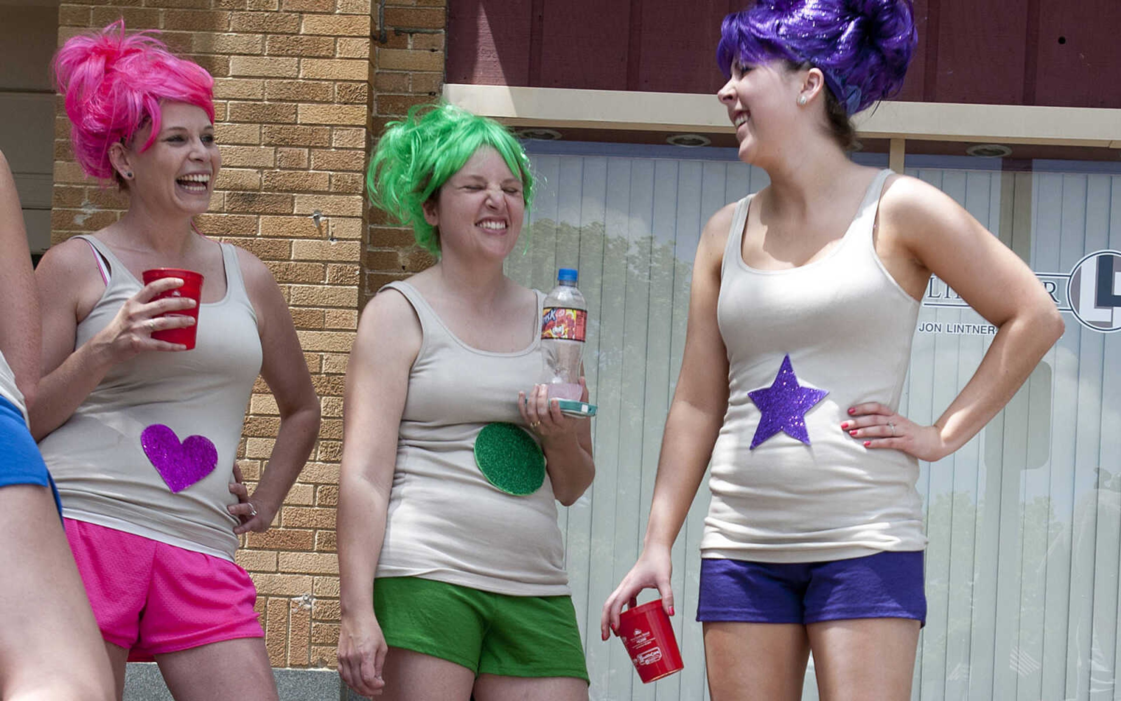 Miranda Abt, left, Sara Best, and Jessica Zoellner wait to compete in the Perryville Mayfest Bed Races Saturday, May 10, in Perryville, Mo. They and their team dressed as "Treasure Trolls," for the event.