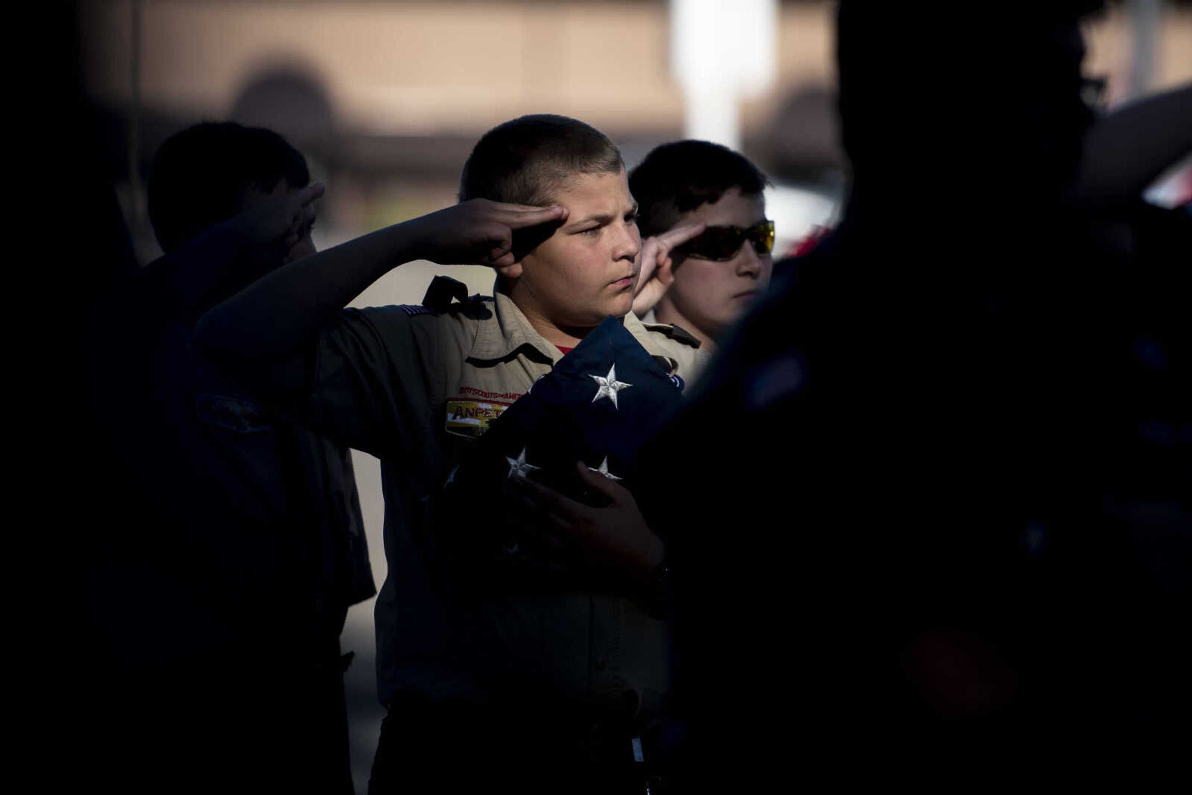 Nick Steams, of Boy Scout Troop 5, salutes while holding an American flag as the National Anthem is sung during the inaugural flag retirement ceremony at VFW Post 3838 Sunday, Oct. 21, 2018, in Cape Girardeau.