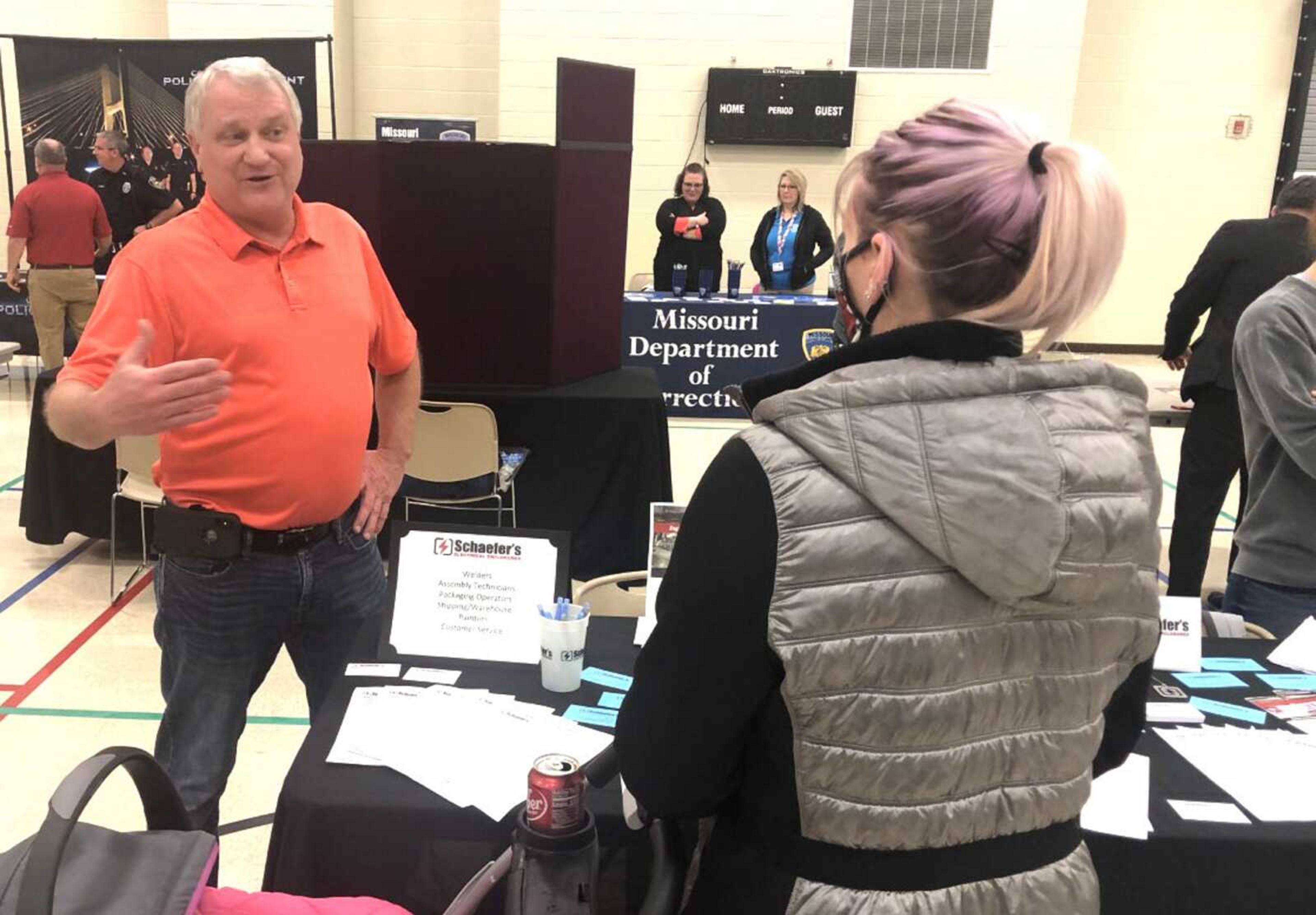 Randy Nelson, president and CEO of Schaefer's Electrical Enclosures in Scott City, talks with Brook Leal of Cape Girardeau about welding positions at his company during the Project C.A.P.E. job fair Thursday at Shawnee Community Center in Cape Girardeau.