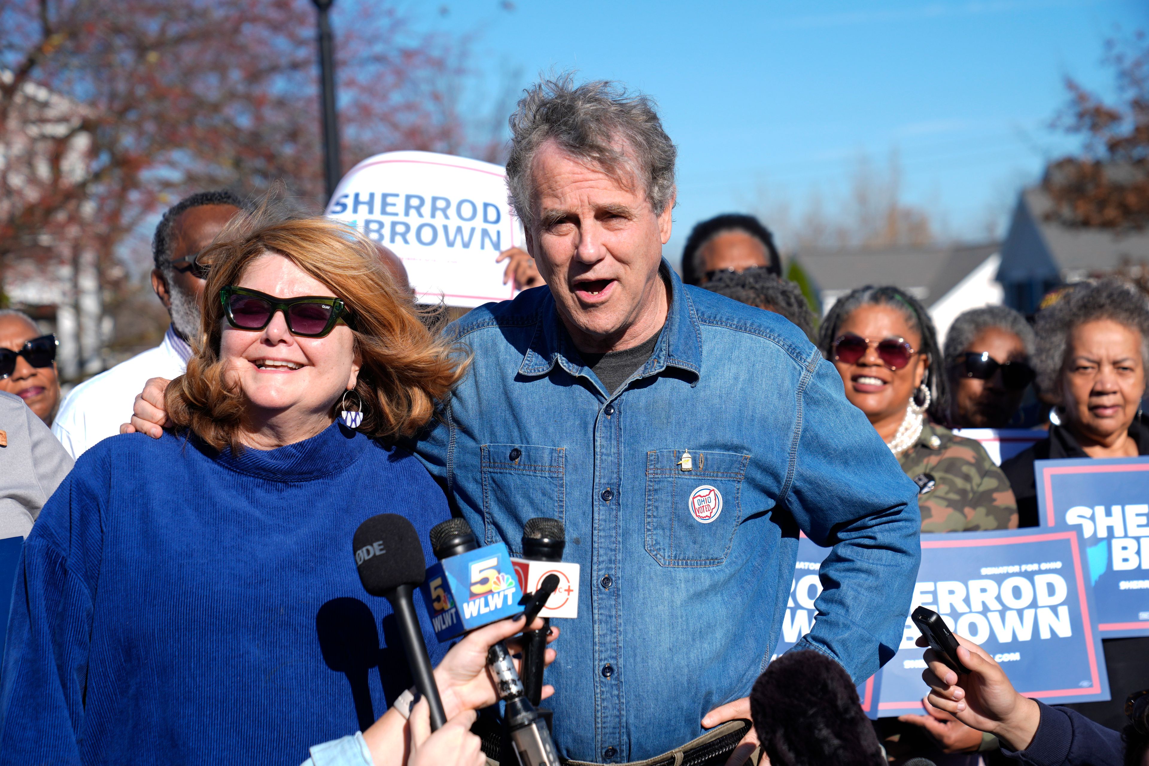 Sen. Sherrod Brown, D-Ohio, right, speaks to the media with his wife Connie Schultz, left, after voting Tuesday, Nov. 5, 2024, in Cleveland. (AP Photo/Sue Ogrocki