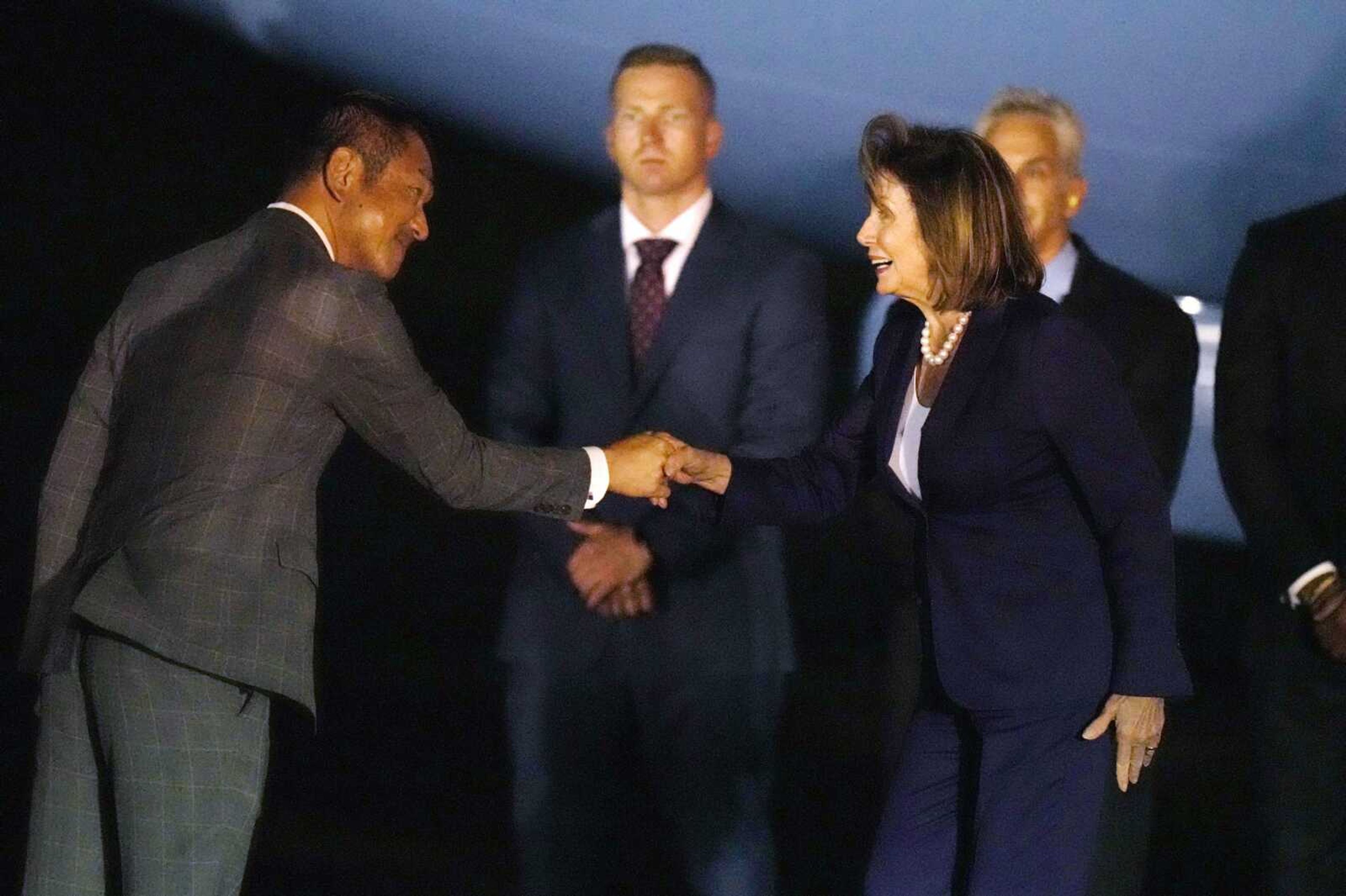 U.S. House Speaker Nancy Pelosi, right, is greeted by Kiyoshi Odawara, Japanese Parliamentary Vice-Minister for Foreign Affairs, on her arrival Thursday at the U.S. Yokota Air Base in Fussa on the outskirts of Tokyo.