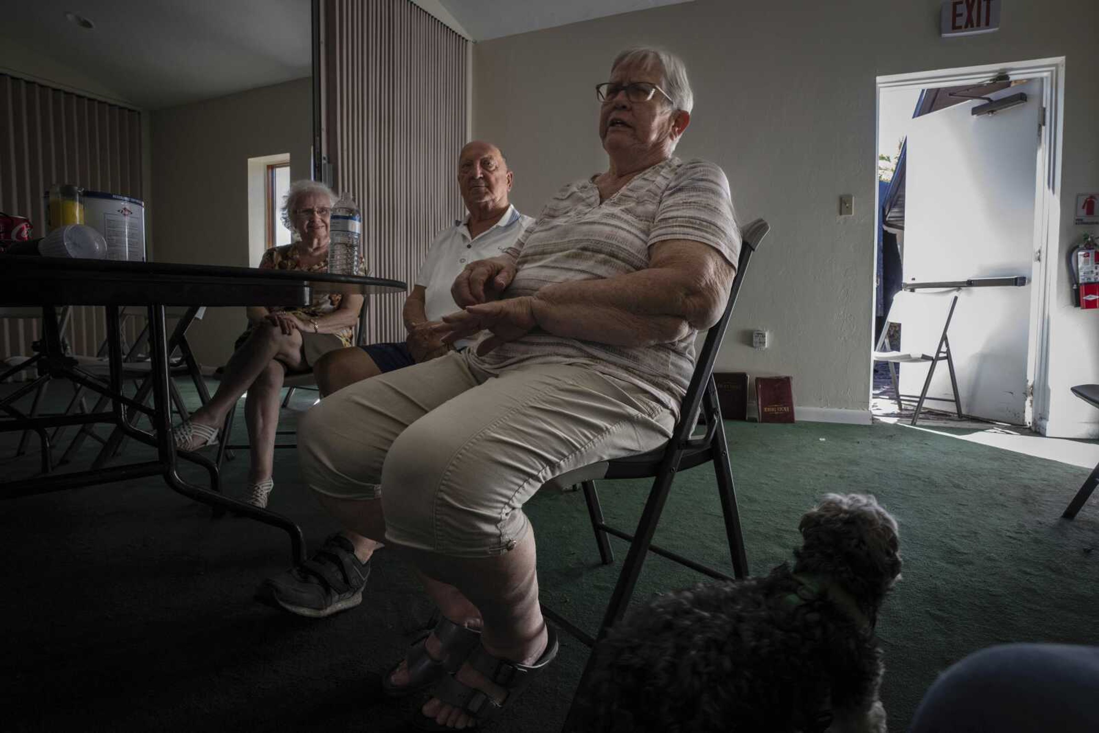 Jane Compton, right, and her husband, Del, center, sit with other parishioners at Southwest Baptist Church on Sunday in Fort Myers, Florida. The Comptons are among nearly a dozen church members who are living at the church after their homes were destroyed by Hurricane Ian.