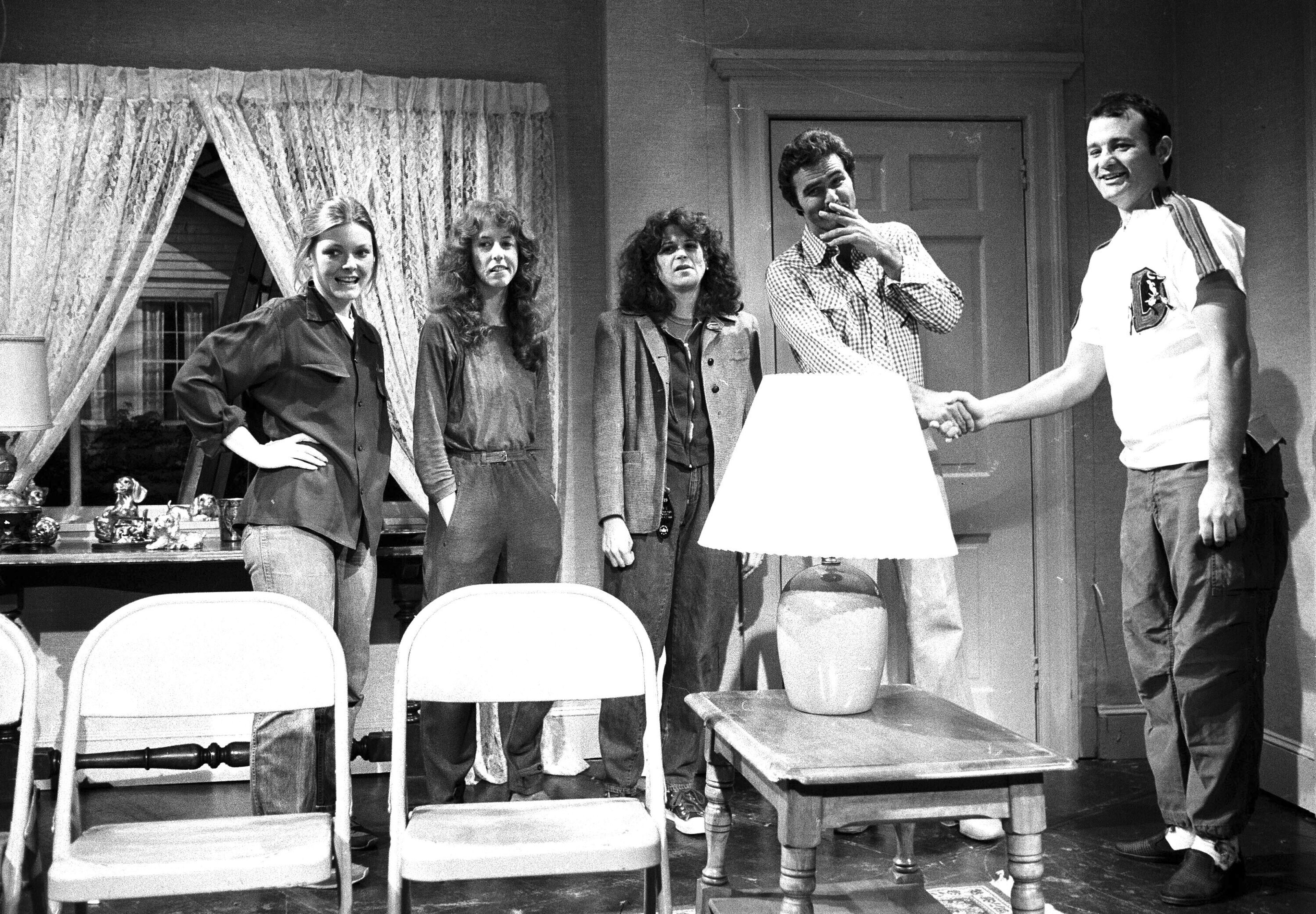 FILE - Actor Burt Reynolds, second right, appears on the set with cast members of NBC's "Saturday Night Live," from left, Jane Curtin, Laraine Newman, Gilda Radner, and Bill Murray, right, in New York, April 12, 1980. (AP Photo/Suzanne Vlamis, File)