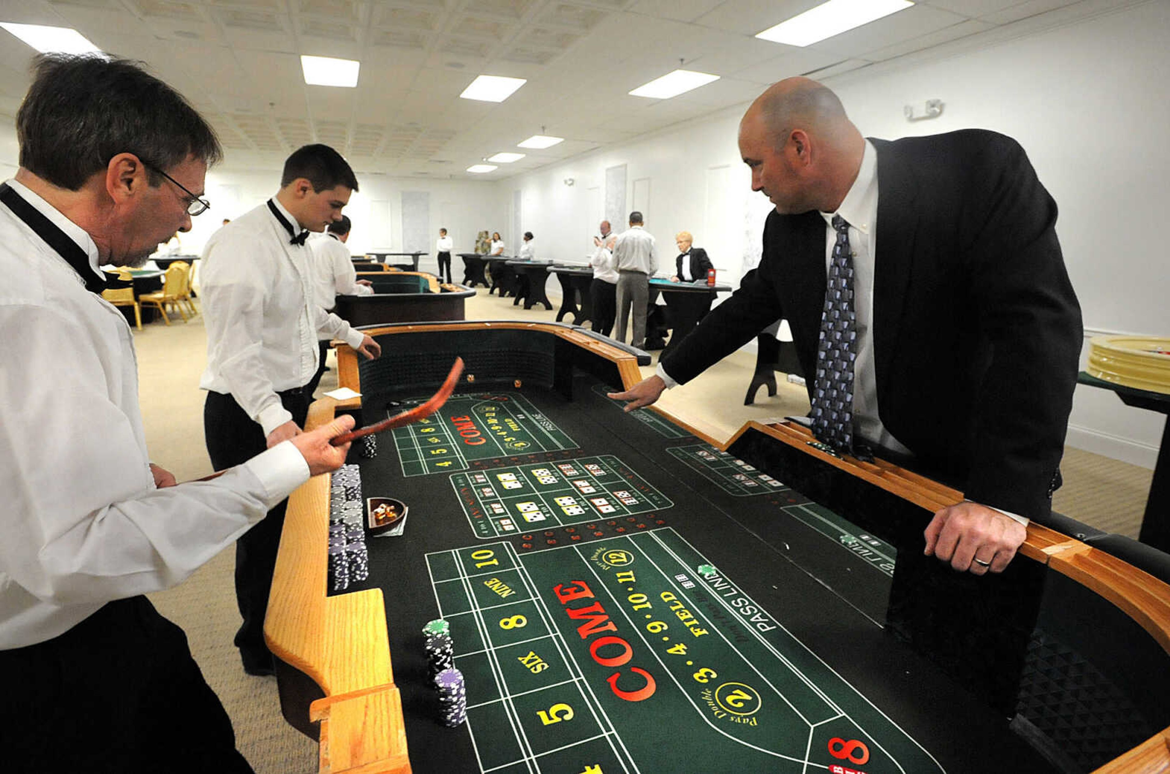 LAURA SIMON ~ lsimon@semissourian.com
Bryan Palmer rolls the dice at the craps table Saturday night, Jan. 26, 2013 during the Notre Dame Regional High School Winter Extravaganza at The Venue.