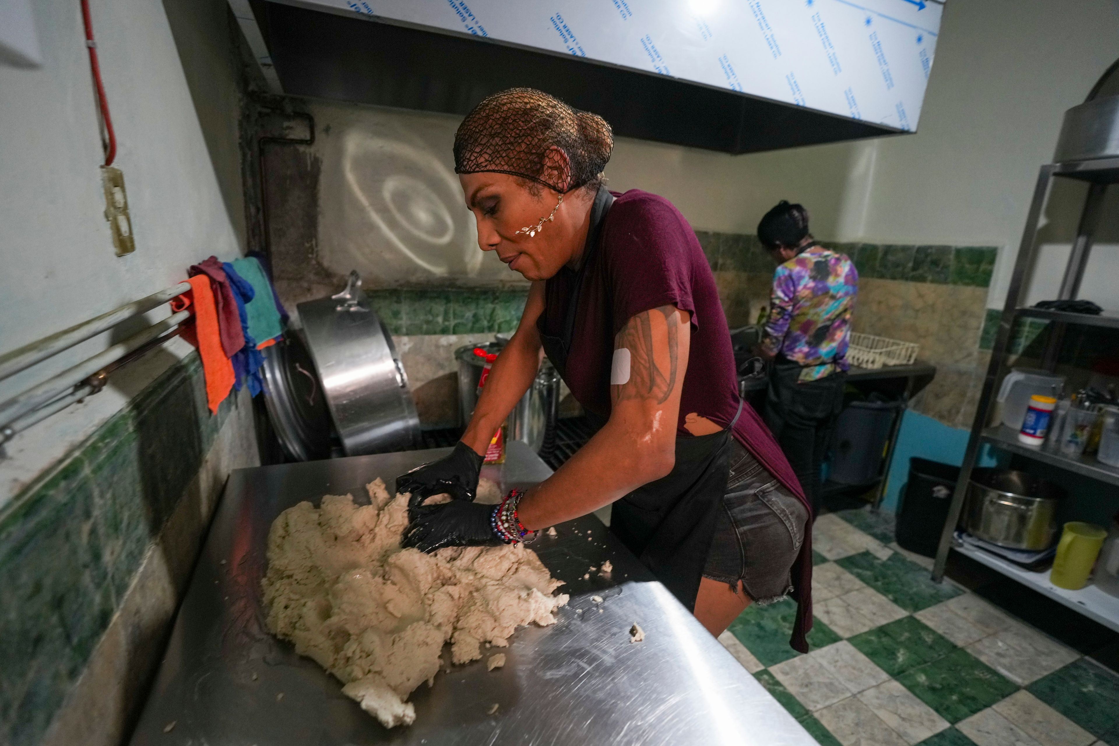 Karolina Long Tain González Rodríguez, a trans woman, prepares dough to make gorditas in a kitchen at Casa Lleca, an LGBTQ+ shelter in the Peralvillo neighborhood of Mexico City, Friday, Sept. 20, 2024. (AP Photo/Fernando Llano)