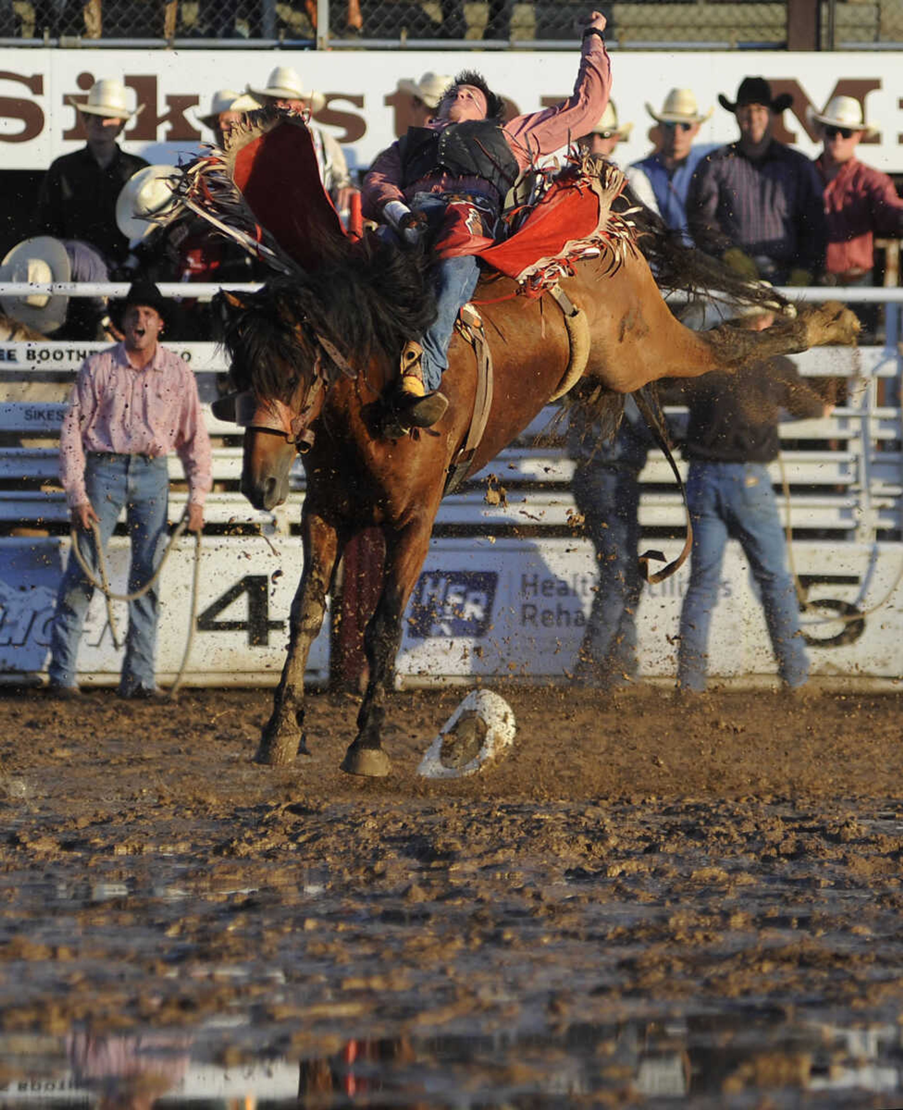 Taylor Price rides Prairie Wind in the bareback riding competition at the Sikeston Jaycee Bootheel Rodeo Wednesday, August 7, in Sikeston, Mo. Price received a score of 84 for his ride.