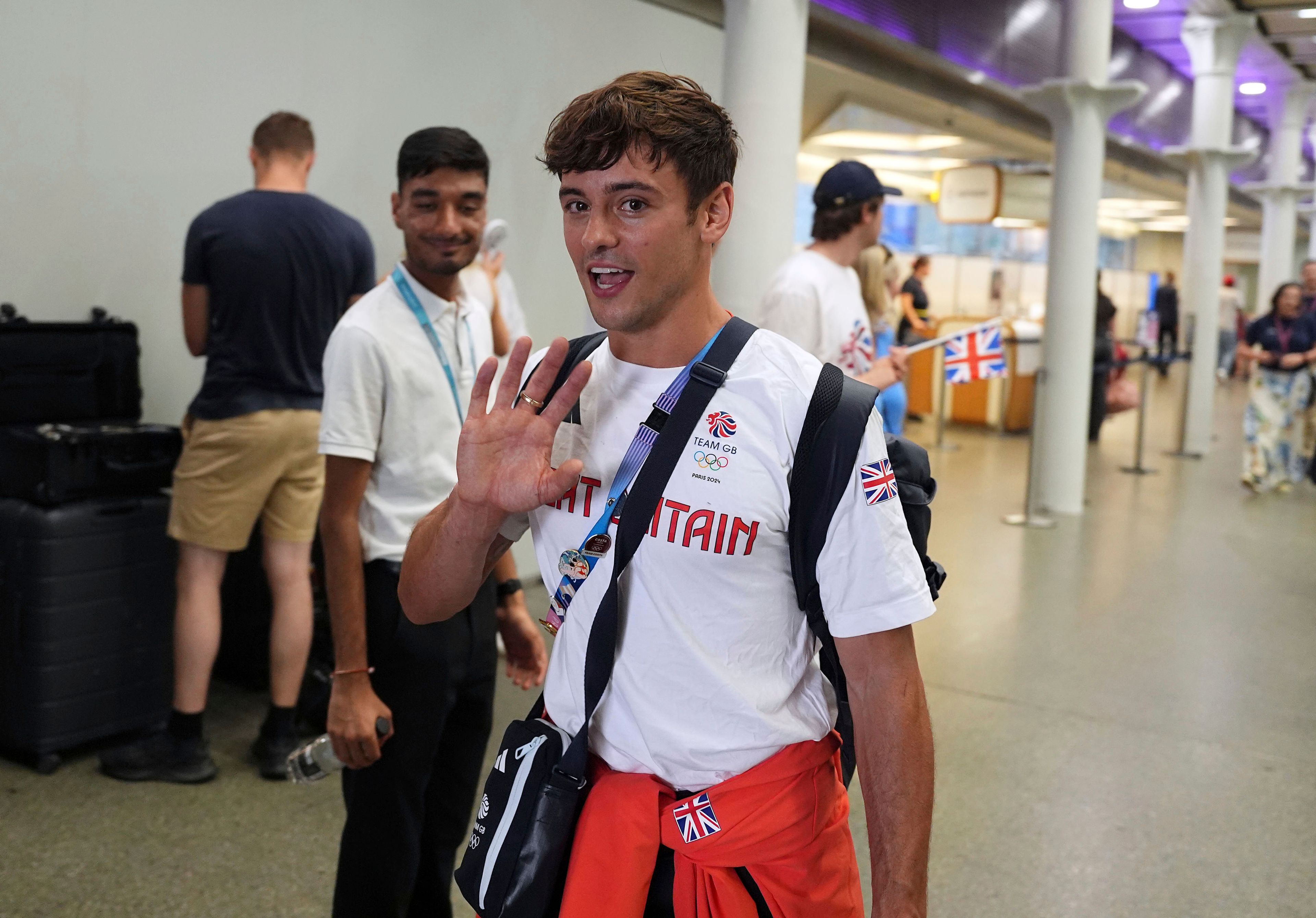 Great Britain's Tom Daley arrives by Eurostar into London St. Pancras International train station after competing at the 2024 Paris Olympic Games in France, Monday Aug. 12, 2024. Five-time Olympic gold medalist Tom Daley has announced his retirement from diving. (Jordan Pettitt/PA via AP)