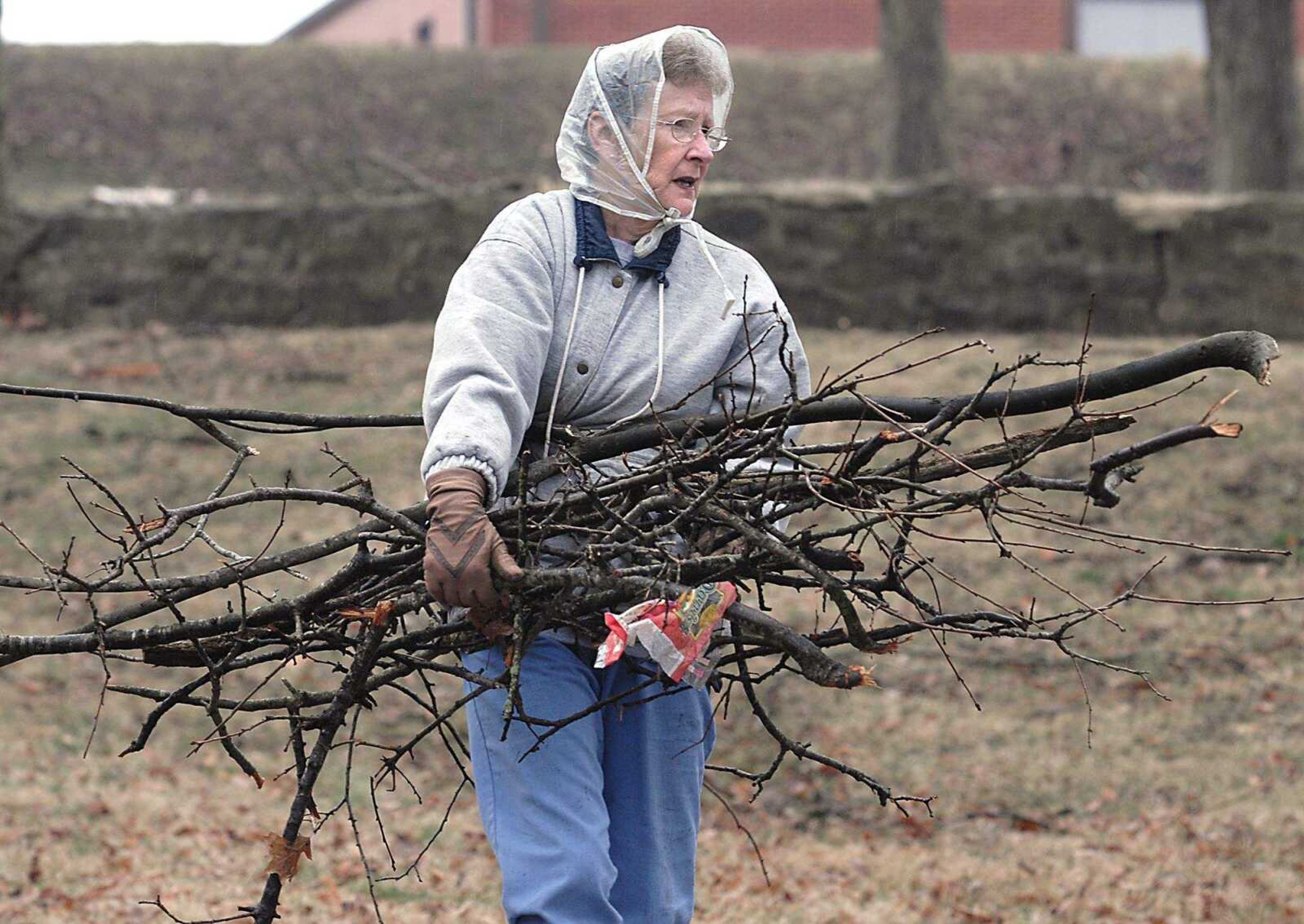 FRED LYNCH ~ flynch@semissourian.com
Juanita Niswonger carried tree debris to the curb Saturday in Jackson City Park.