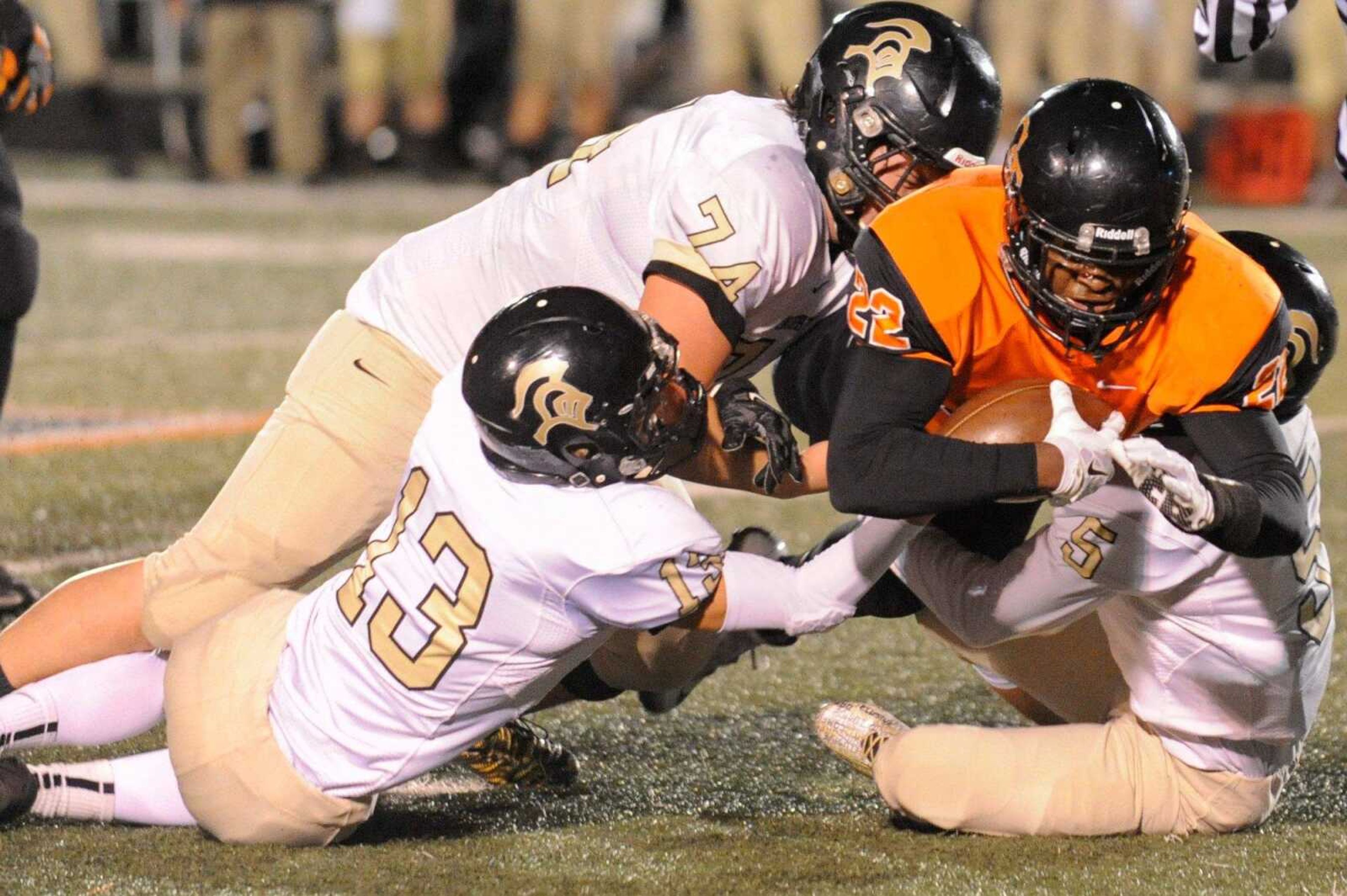 Cape Central's Aaron Harris dives past Farmington defensive players in the first quarter Friday, Oct. 2, 2015 in Cape Girardeau. (Glenn Landberg)