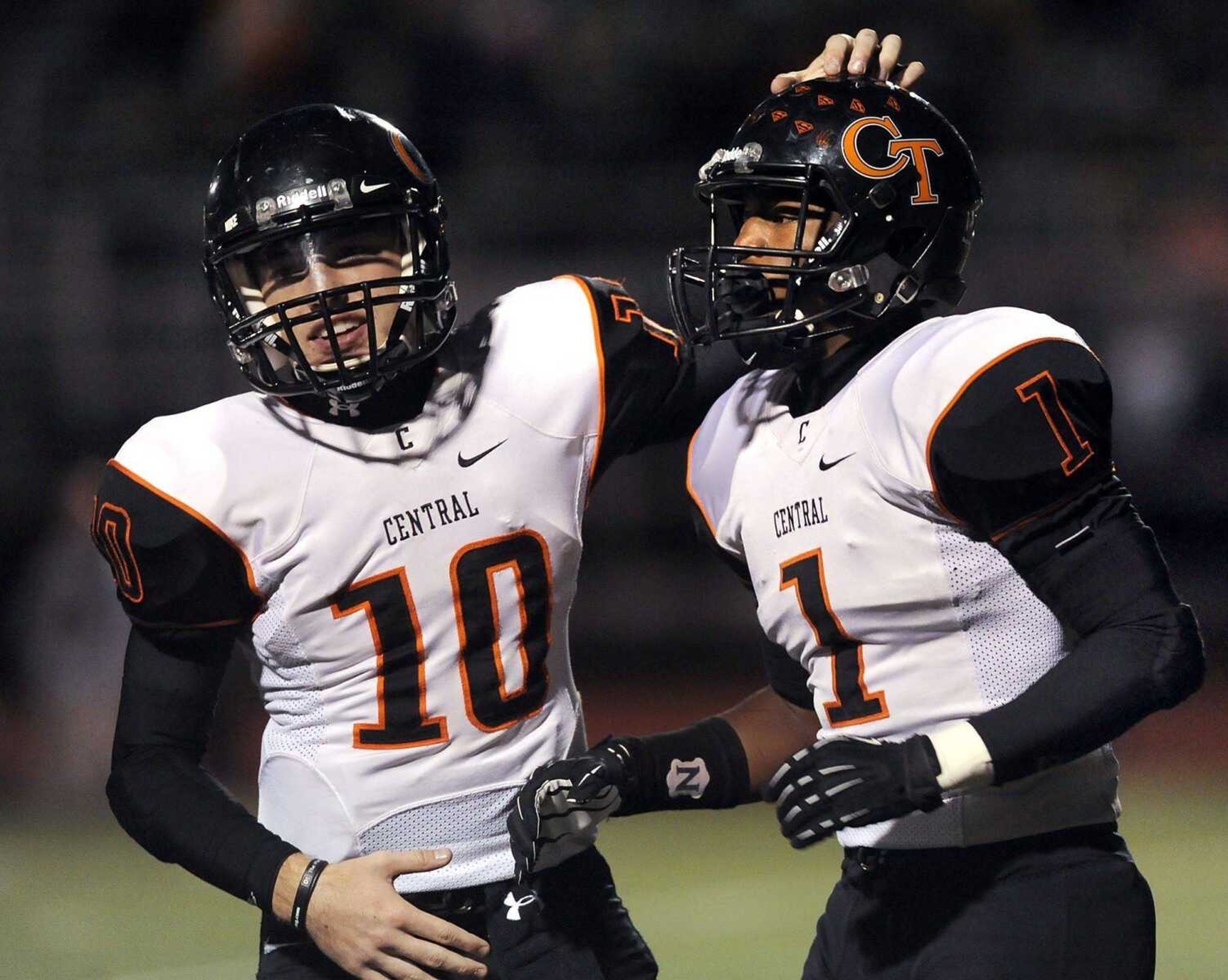 Central quarterback Peyton Montgomery, left, celebrates with Al Young after Young scored the second touchdown against Farmington during the first quarter Friday, Oct. 3, 2014 in Farmington, Missouri. (Fred Lynch)