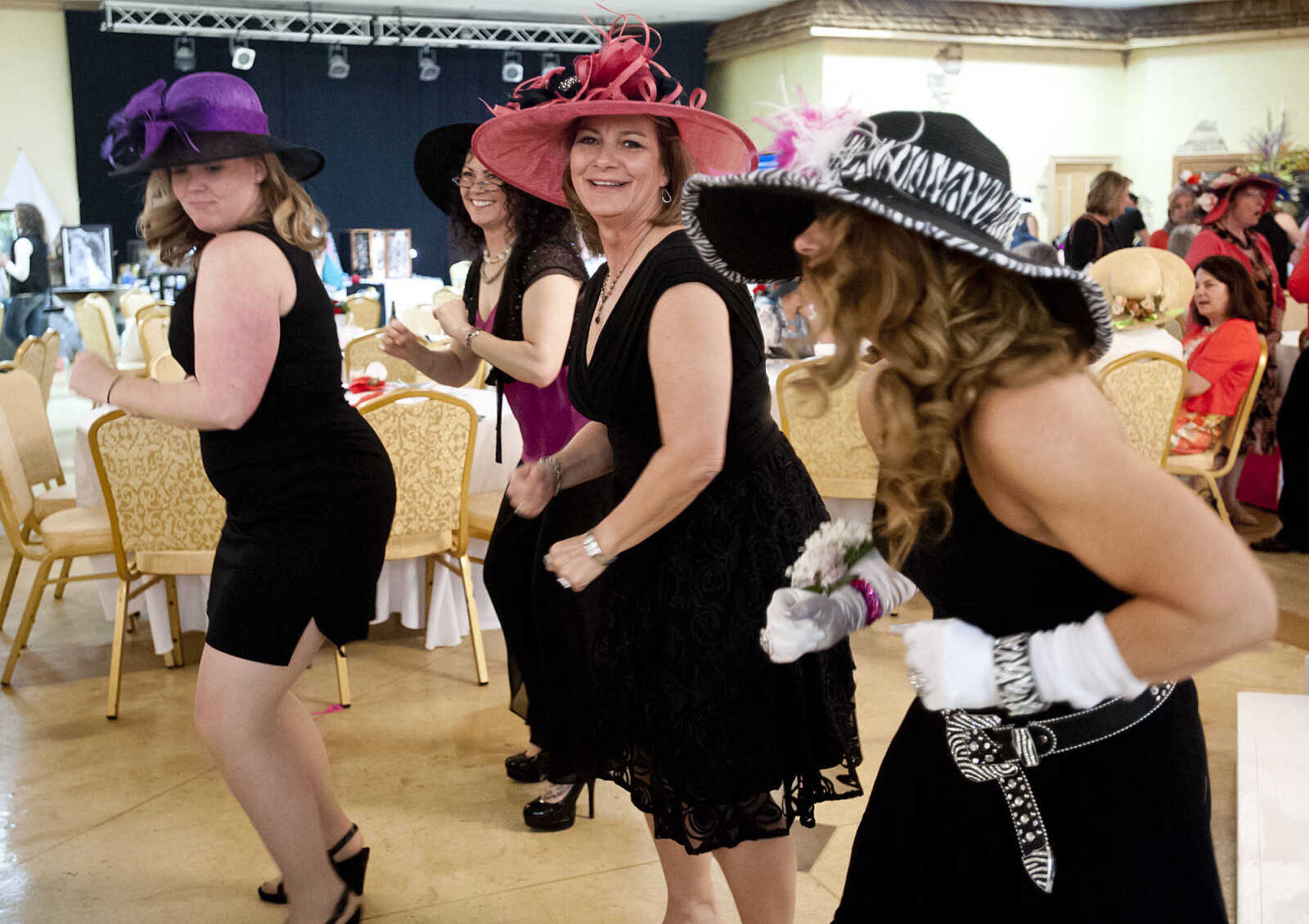 Attendees dance "TheWobble," at the Lutheran Family and Children's Services Foundation's "Boas & Bling, Kentucky Derby Party," Thursday, May 1, at The Venue in Cape Girardeau. More than 450 people attended the annual event  which is a fundraiser for the not-for-profit social services organization which provides counseling, adoption services, child care, youth mentoring services and advocacy on behalf of children and families.