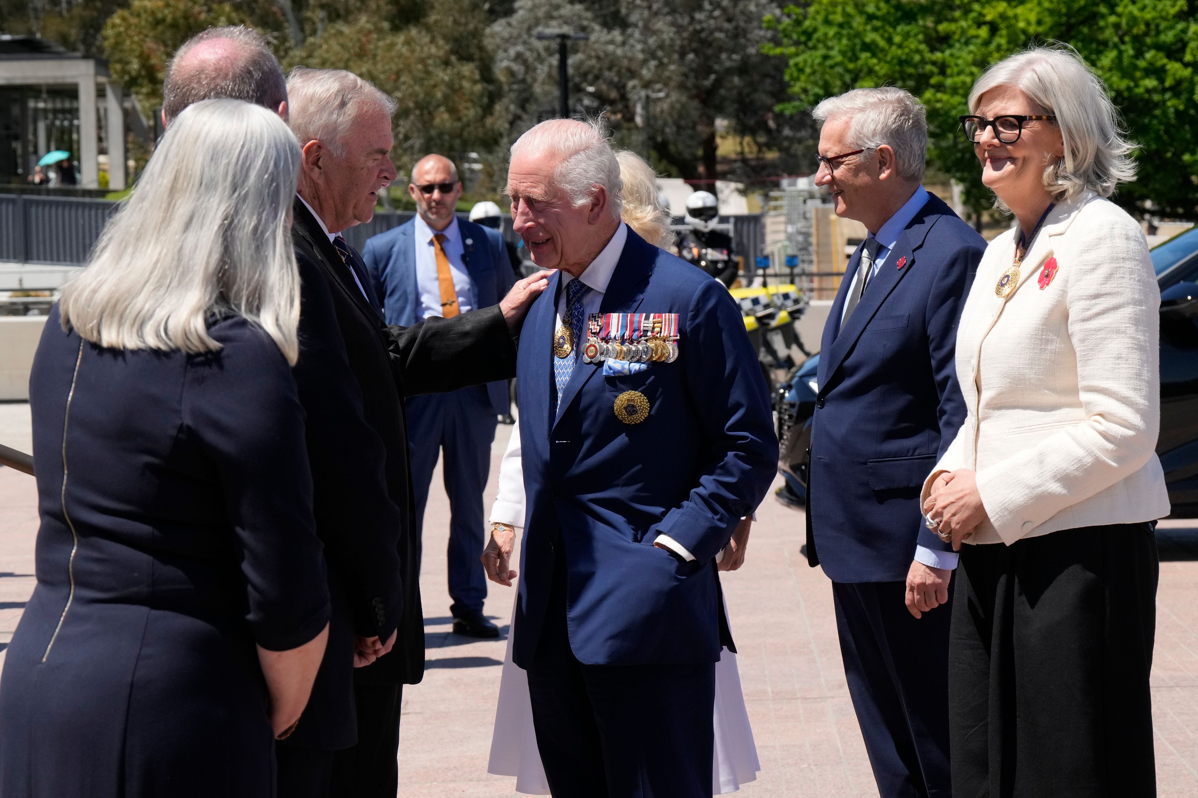 Kim Beazley, third left, chair of Australian War Memorial Council, meets Britain's King Charles III, center, on the king's arrival with Queen Camilla, partially seen at rear center, in Canberra, Australia, Monday, Oct. 21, 2024.